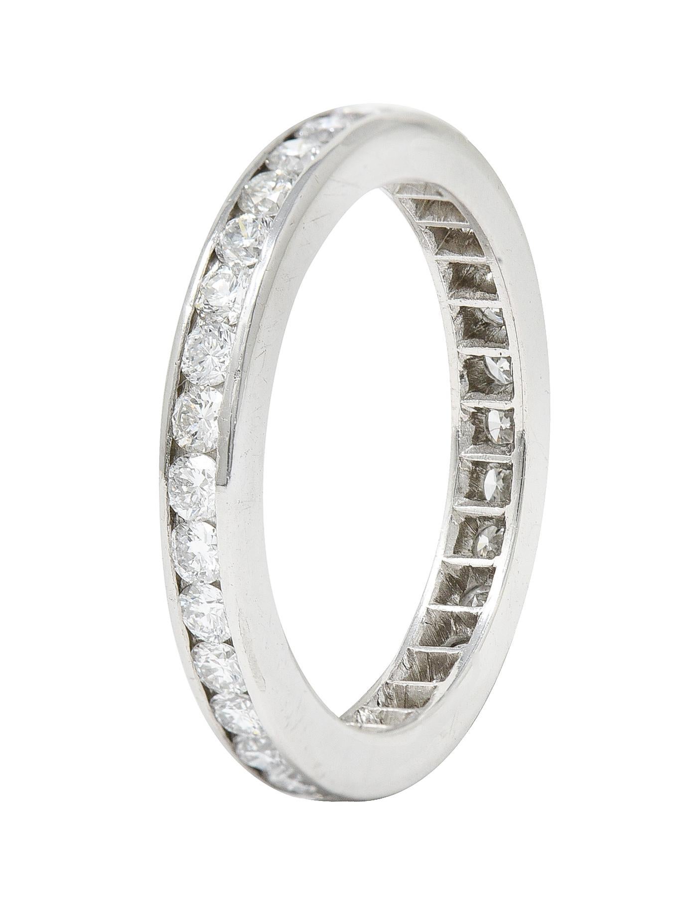 Band ring features round brilliant cut diamonds channel set fully around

Weighing approximately 0.96 carat total - G/H in color with VS clarity

With high polished platinum finish

Tested as platinum

Circa: 21st century

Ring size: 5 3/4 and not