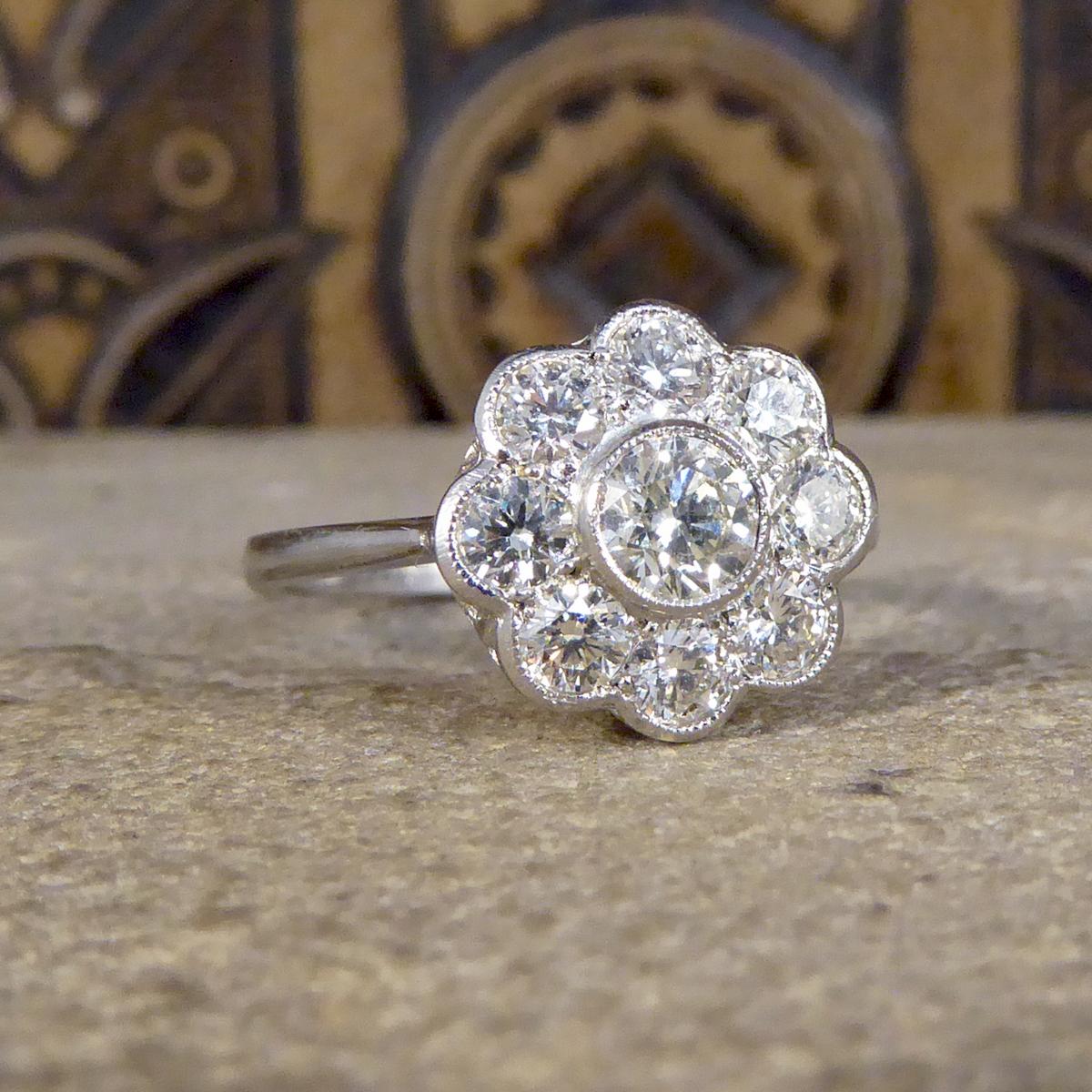 This fabulous Daisy cluster ring has a total of 1.05ct Brilliant cut Diamonds and sparkles with from all angles in its cluster setting. All set in Platinum with a milegrain edge with a beautiful gallery, leading to a plain band and is a true