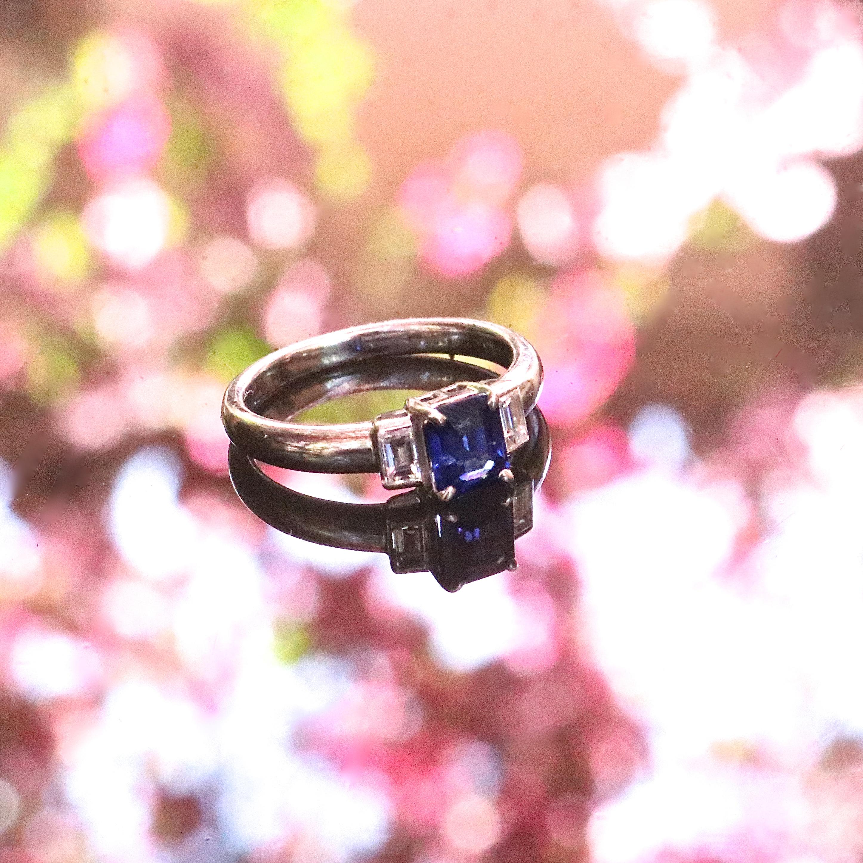 Modern 1.06 carat sapphire diamond platinum ring. With 2 baguette cut diamonds graded E-F color, VS+ clarity. Circa 2000s. Size 6 and comes with complimentary sizing if needed. 
Our 1stdibs Recognized Dealer/Platinum Seller Guarantees: 
7 day return