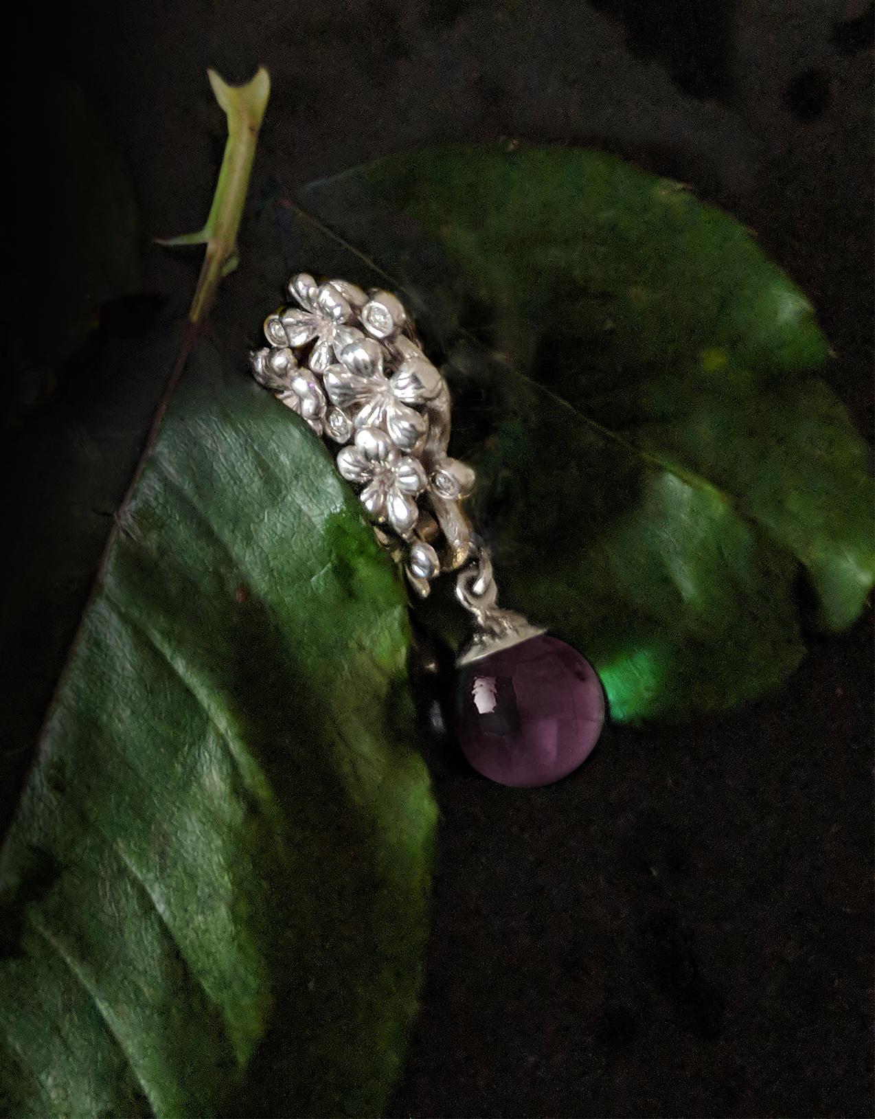 The 14 karat white gold Plum Blossom contemporary pendant necklace is encrusted with five round diamonds and a cabochon rose quartz drop, and has been featured in a review by Vogue UA. We use only top-quality natural diamonds of VS clarity and F-G