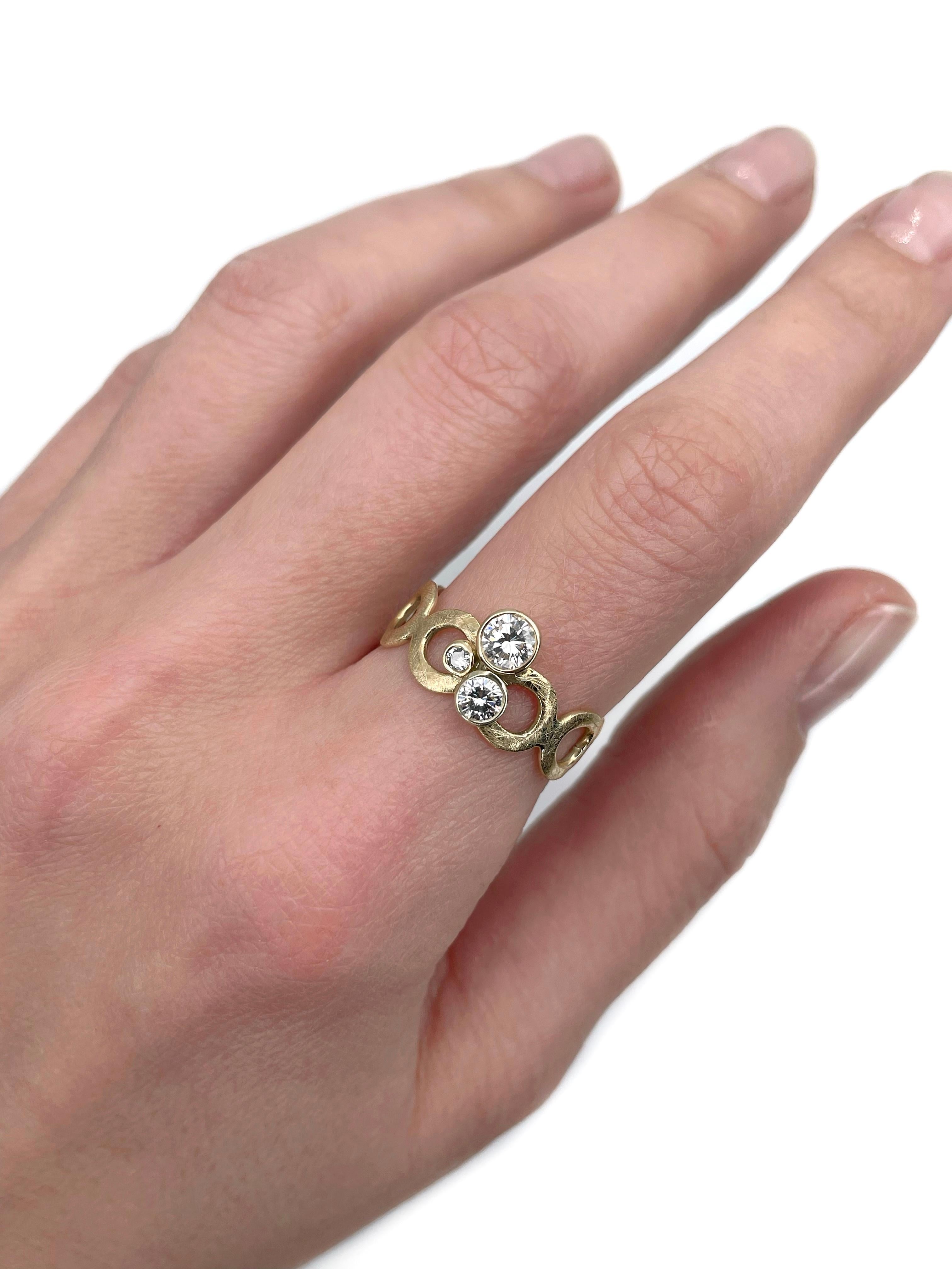 This is a modern design ring crafted in 14K yellow gold. Circa 2000. 

It features diamonds (TW 0.52ct):
- 1 diamond (round brilliant cut, 0.30ct, RW-W, VVS-VS)
- 2 diamonds (round brilliant cut, TW 0.22ct, RW-W, VVS-VS)

Weight: 3.21g
Size: 18.25