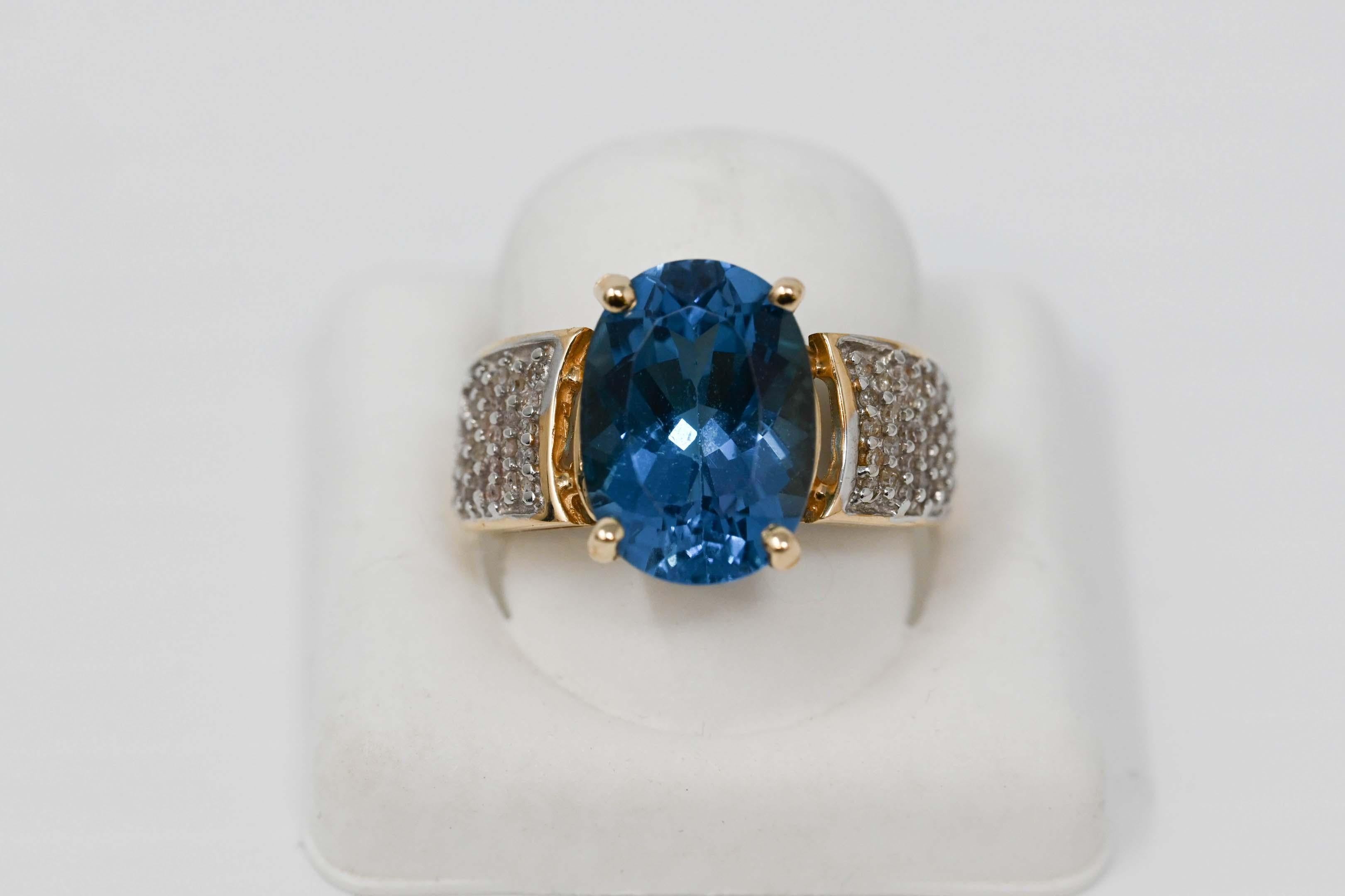 14k gold ladies ring set with a iolite gemstone 14 x 11 mm and 78 genuine diamond stones. Size 8, stamped 14k inside, maker mark unknown. Weighs 7.7 grams.
