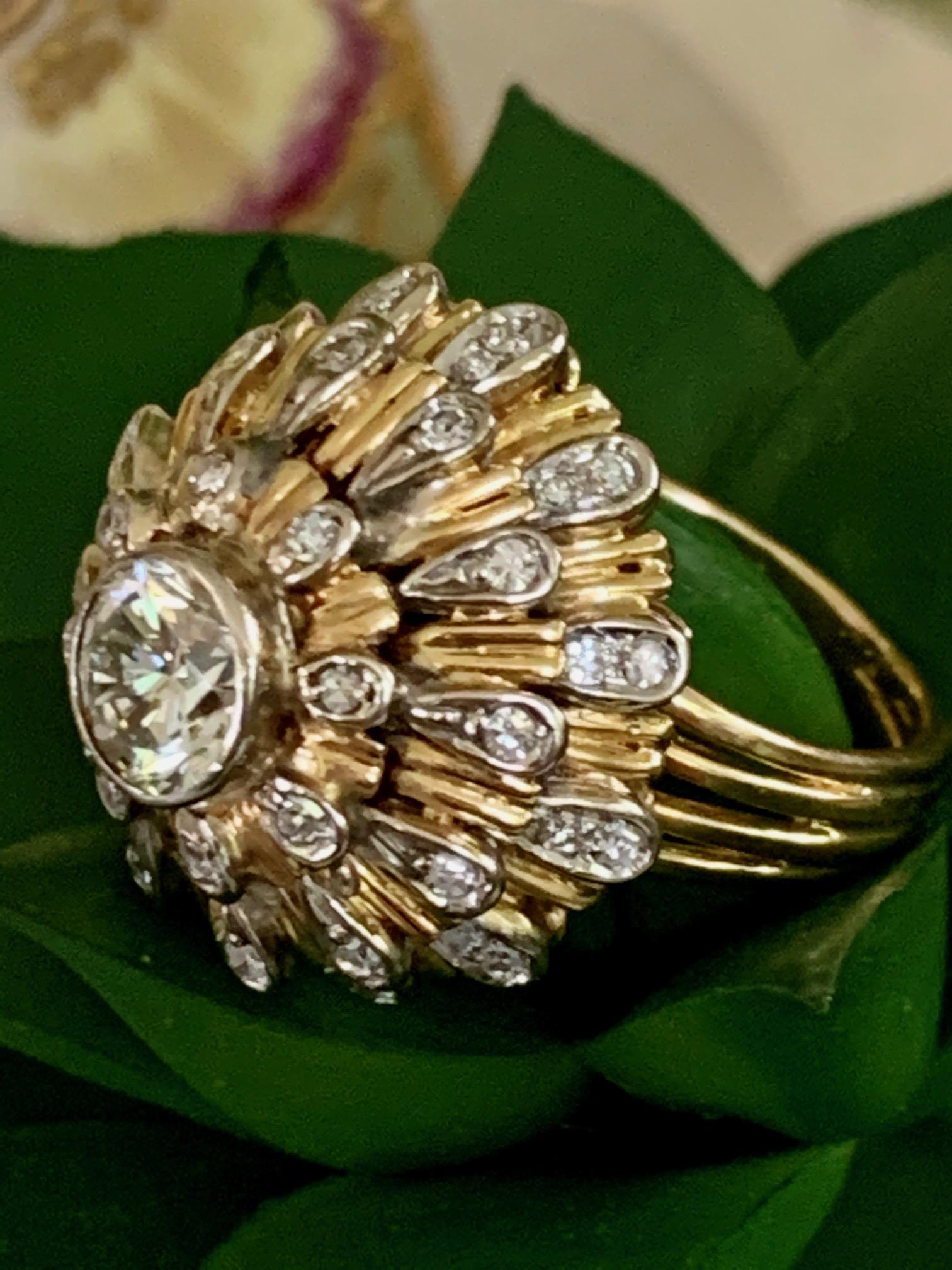 This dome ring features a 1.0ct bezel set, brilliant cut Diamond as the center stone which measures 6,4mm. The grade is approximately VS-KL.  The center Diamond is surrounded by single cut Diamonds weighing .70ctw.

Weight: 12.4 grams
Size: 6