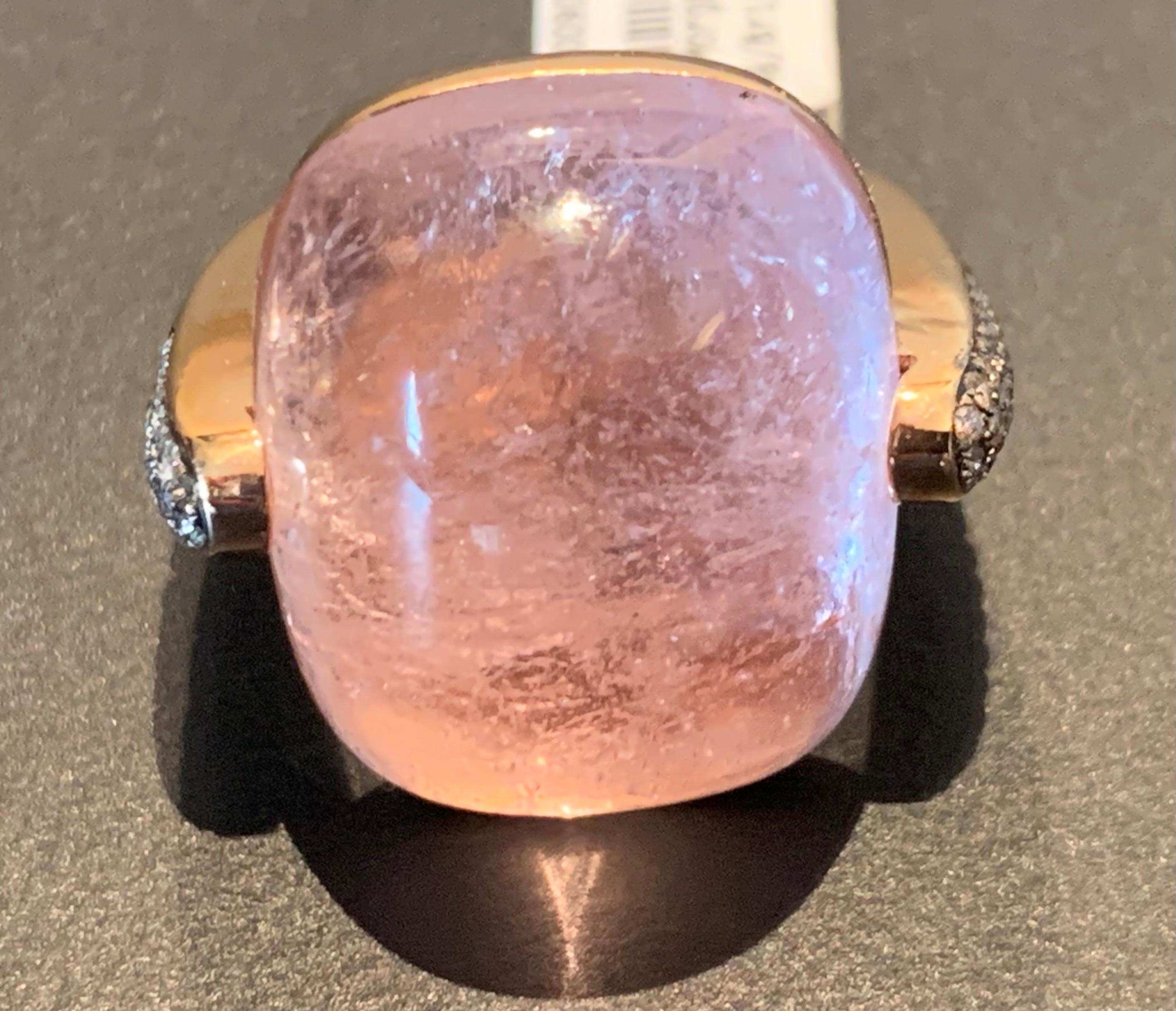 Modern and very wearable 18 K rose Gold Ring featuring a mysterious Morganite weighing 31.46 ct.  The ring shoulders are set with 46 brilliant cut Champagne Diaomods with a total weight of 0.31 ct. 
The ring is currently size 16 (US size 8  but can