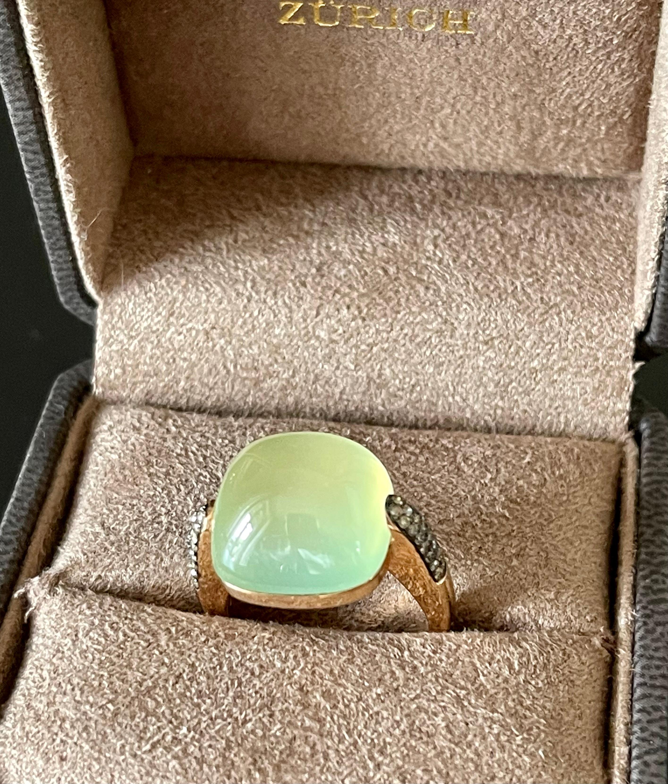 Modern and very wearable 18 K rose Gold Ring featuring a mint green Prehnite Cabochon weighing 2.54 ct. The ring shoulders are set with 46 brilliant cut Champagne Diaomods with a total weight of 0.33 ct. 
The ring is currently size 17 (US size 8