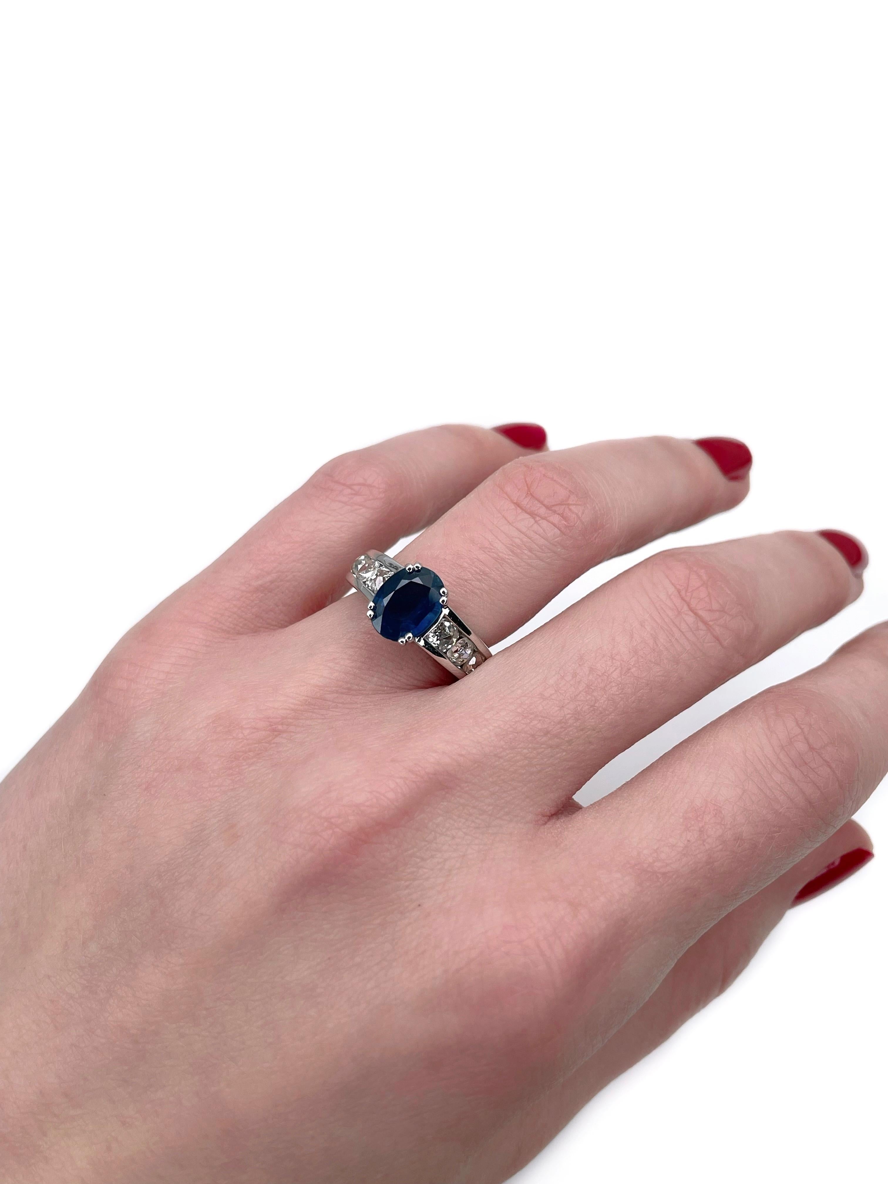 This is a modern design engagement ring crafted in 18K white gold. Circa 2010. 

The piece features:
- 1 sapphire (oval cut, 1.75ct, B 7/4, SI)
- 8 diamonds (old mine cut, TW 1.40ct, RW-W, SI-P1)

Weight: 7.97g
Size: 15.5 (US 4.75)

IMPORTANT:
