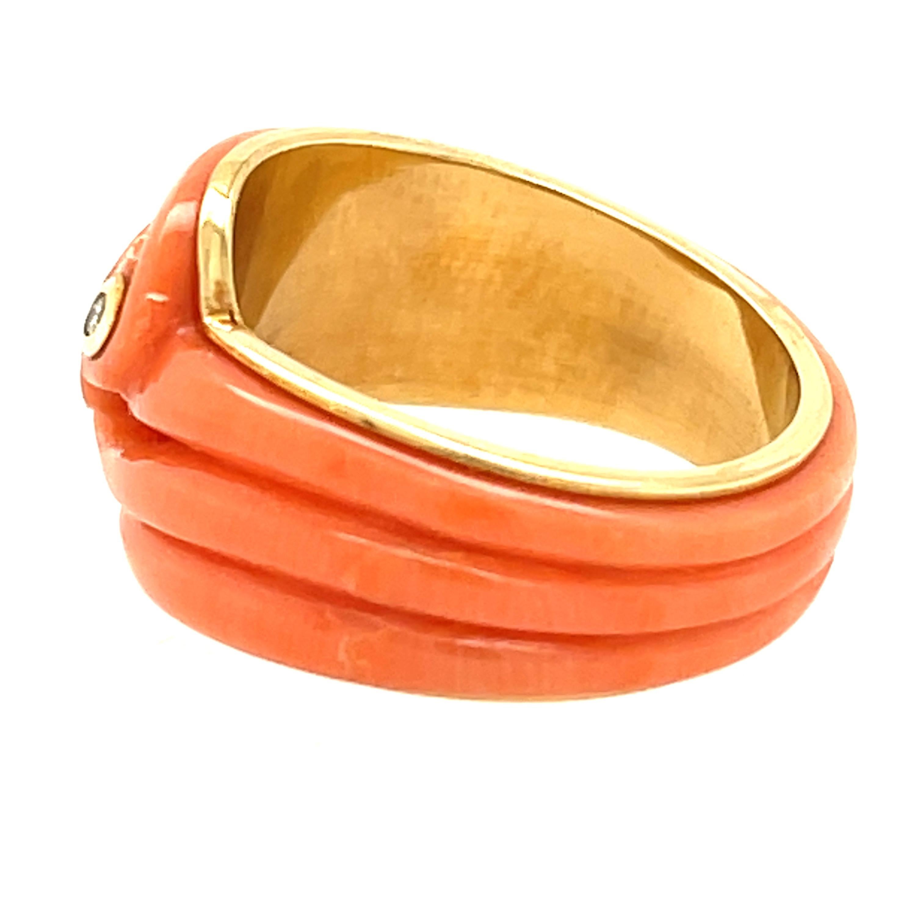 A charming wave themed carved coral 18k yellow gold band ring, circa 2000. This ring is charming and well made without a seam meaning a piece of coral was to make the ring. It has great flow and is smooth and feels good to the touch. The ring has