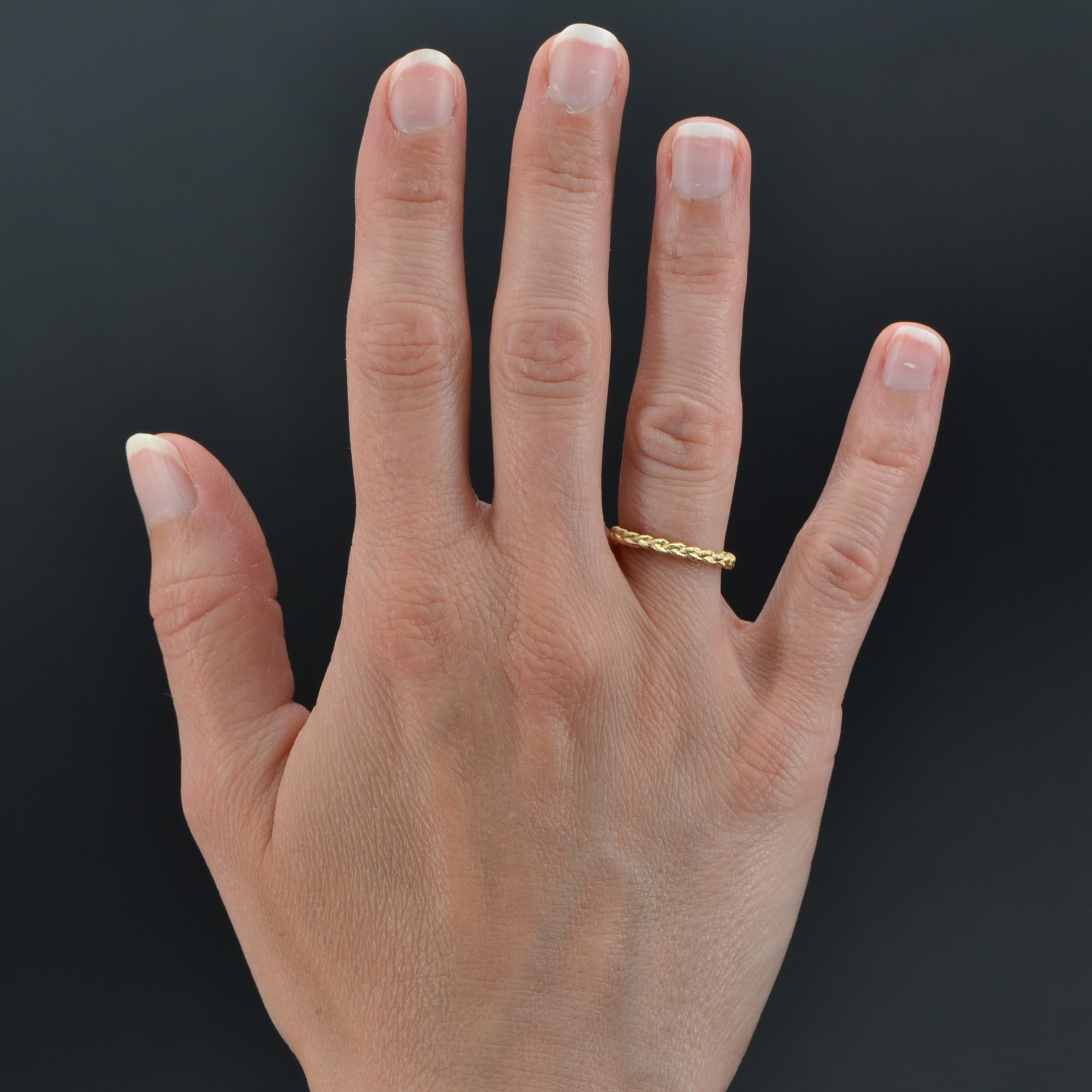 Wedding ring in 18 karat yellow gold.
Charming yellow gold wedding ring, it is formed of a braid of chiseled yellow gold.
Height : 2,3 mm, thickness : 1,5 mm approximately.
Total weight of the jewel : 2,2 g approximately.
US Size : 5,5 ; Free