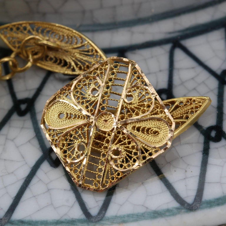 Cufflinks in 18 karat yellow gold.
Each gold cufflink is square, openwork filigree, held to its attachment in the form of shuttle of the same decoration, by small rings.
Height : 16.3 mm, width : 16.1 mm, thickness : 1.3 mm, height of the shuttle :