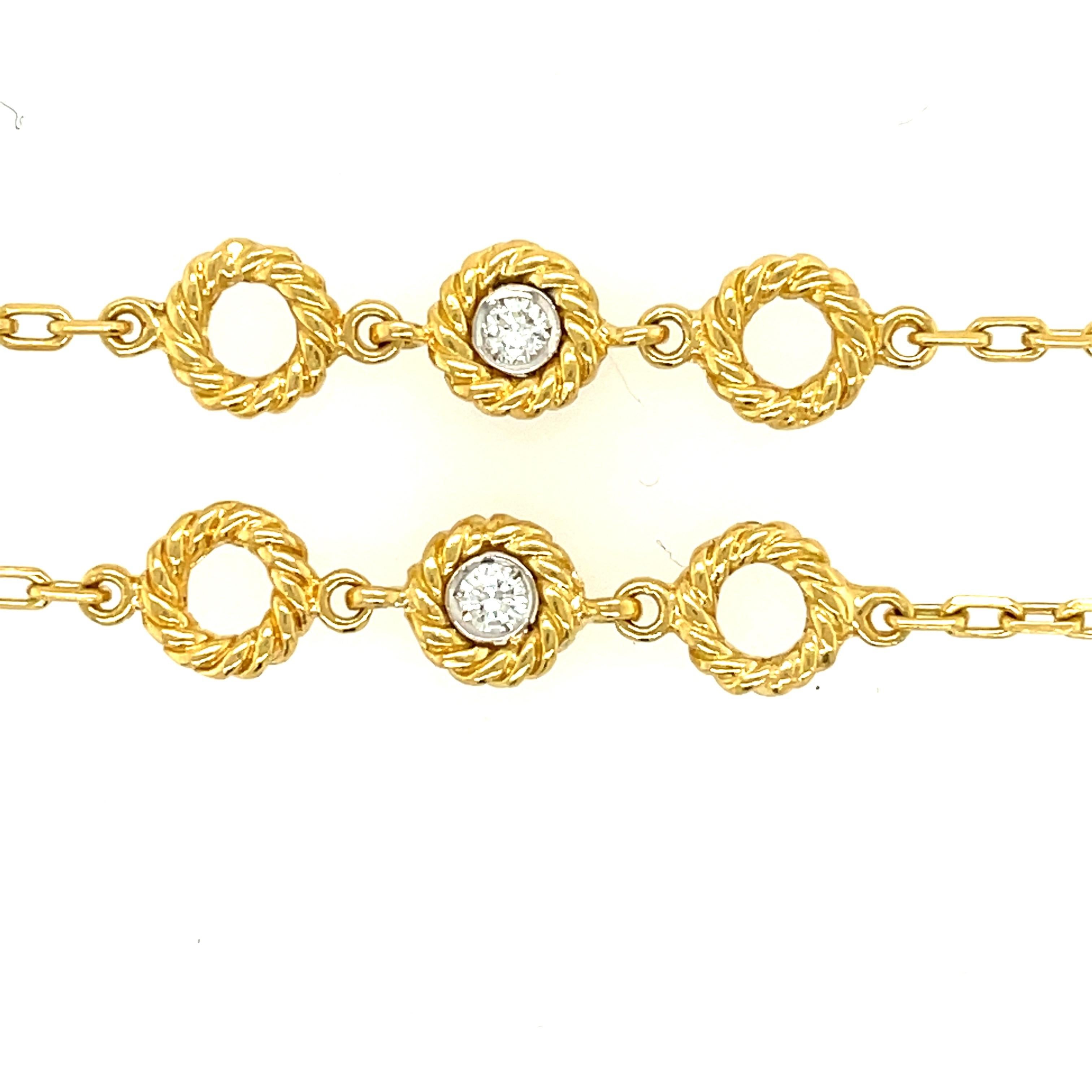 A wearable 18k yellow gold link chain with twisted gold sections and bezel set diamonds, circa 2000. The necklace has a clasp and safety which is nice if you want to layer the necklace. The chain is set with 7 Round Brilliant diamonds, approximately