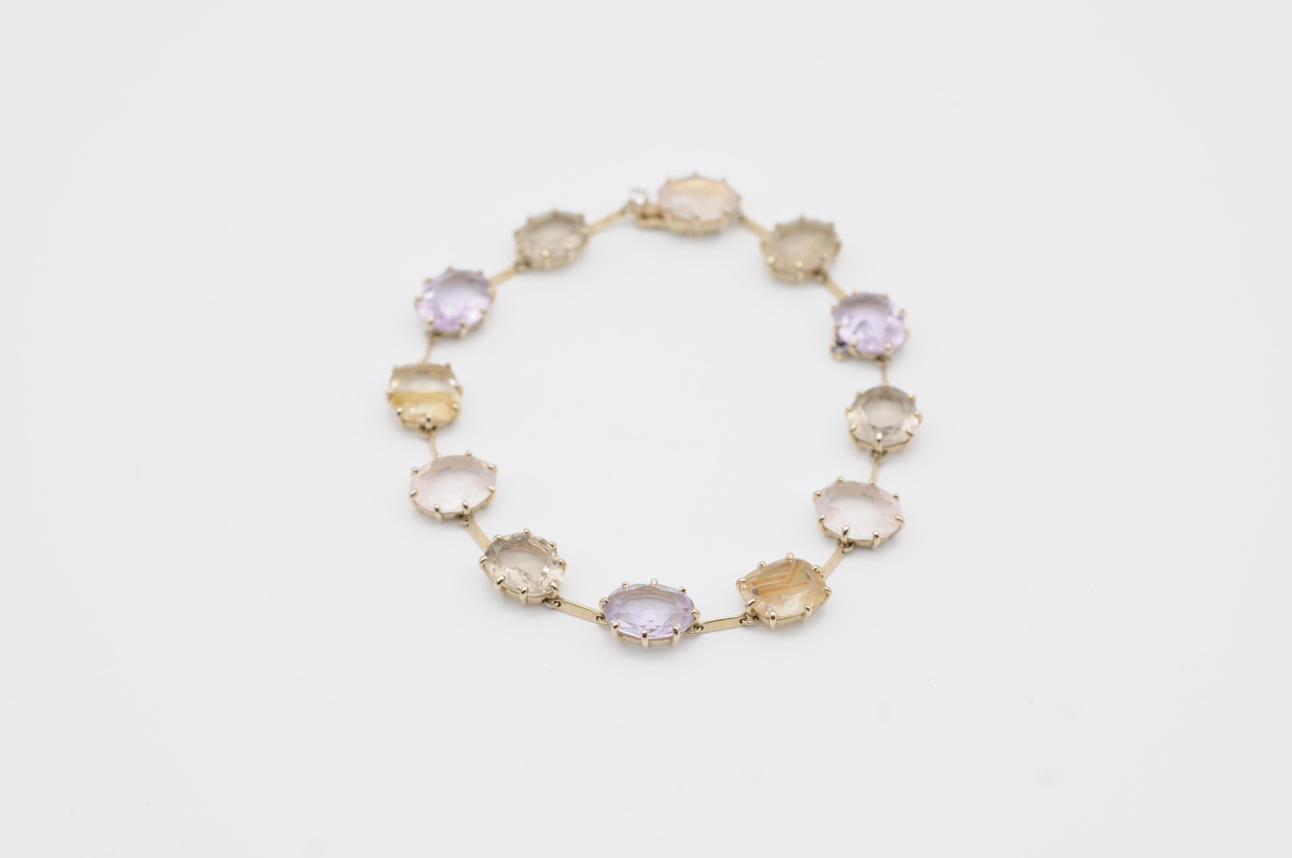 Indulge yourself in the exquisite beauty of this modern bracelet, a stunning piece of artistry that radiates charm and elegance. Crafted from 18K yellow gold, this bracelet features irregularly shaped semiprecious stones that include citrine,