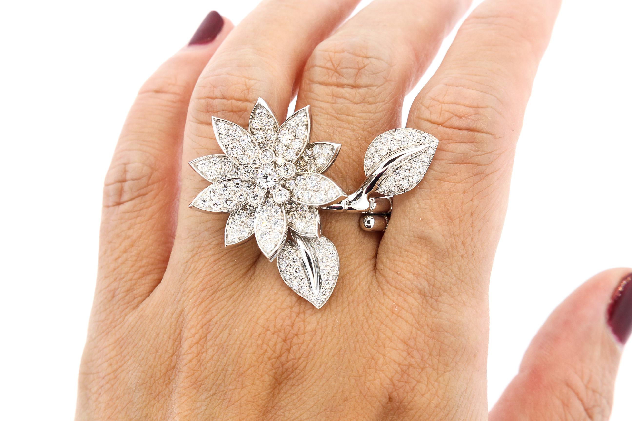 A beautiful Van Cleef & Arpels Lotus Between the Finger Ring. This ring has a lotus flower motif with diamonds. The lotus is the symbol of beauty, purity and fulfillment. There are approximately 2 carats of diamonds that are D to F color and VVS