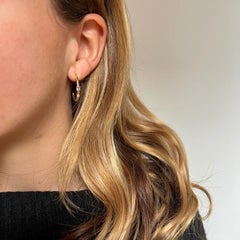 Modern 18k yellow gold half-open hoops with an oval tourmaline rosa and diamond