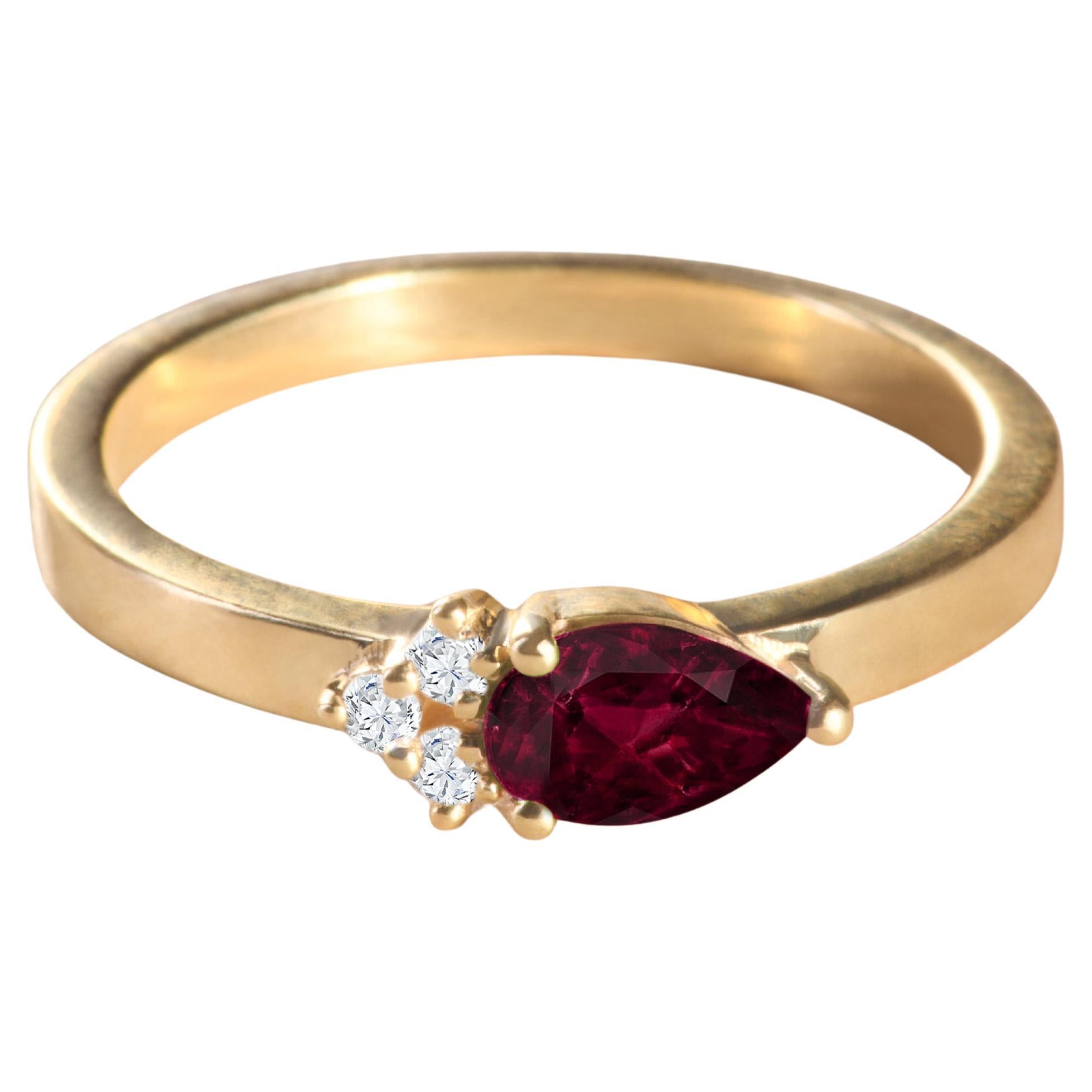 Modern 18k yellow gold ring with a pear-cut Ruby and 3 round diamonds