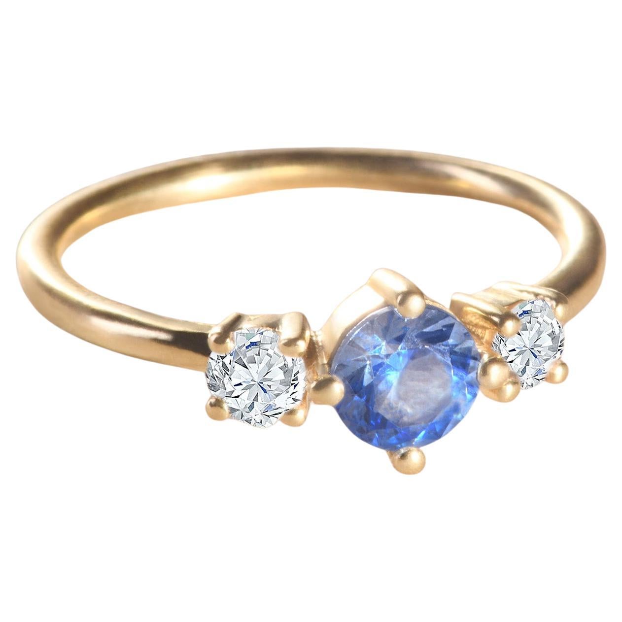 For Sale:  Modern 18k yellow gold ring with a round blue aquamarine and two round diamonds