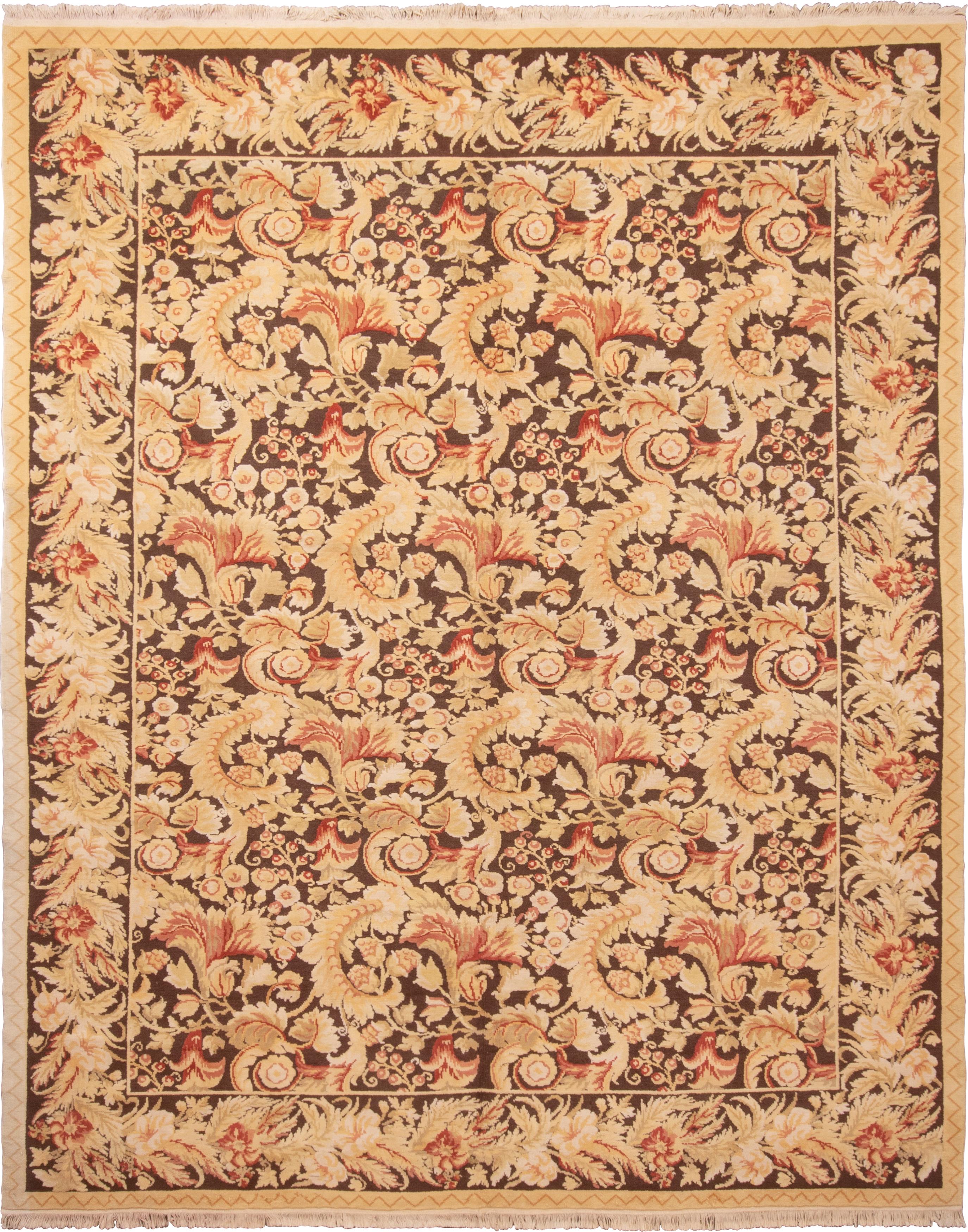 Originating from China, this transitional wool rug enjoys a modern interpretation of an 18th century design. Hand knotted in high quality wool, the all-over field design distinctly resembles the neoclassical golden-beige, brown, and pink colorways