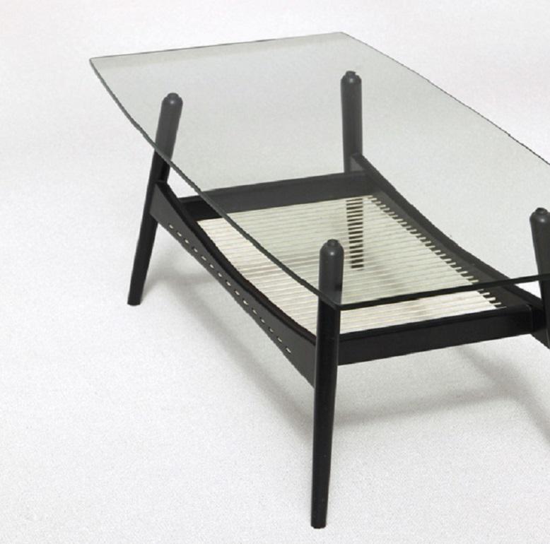 Modern rectangular black painted finish wood coffee table with glass top. Typical modern 50s coffee table.
  