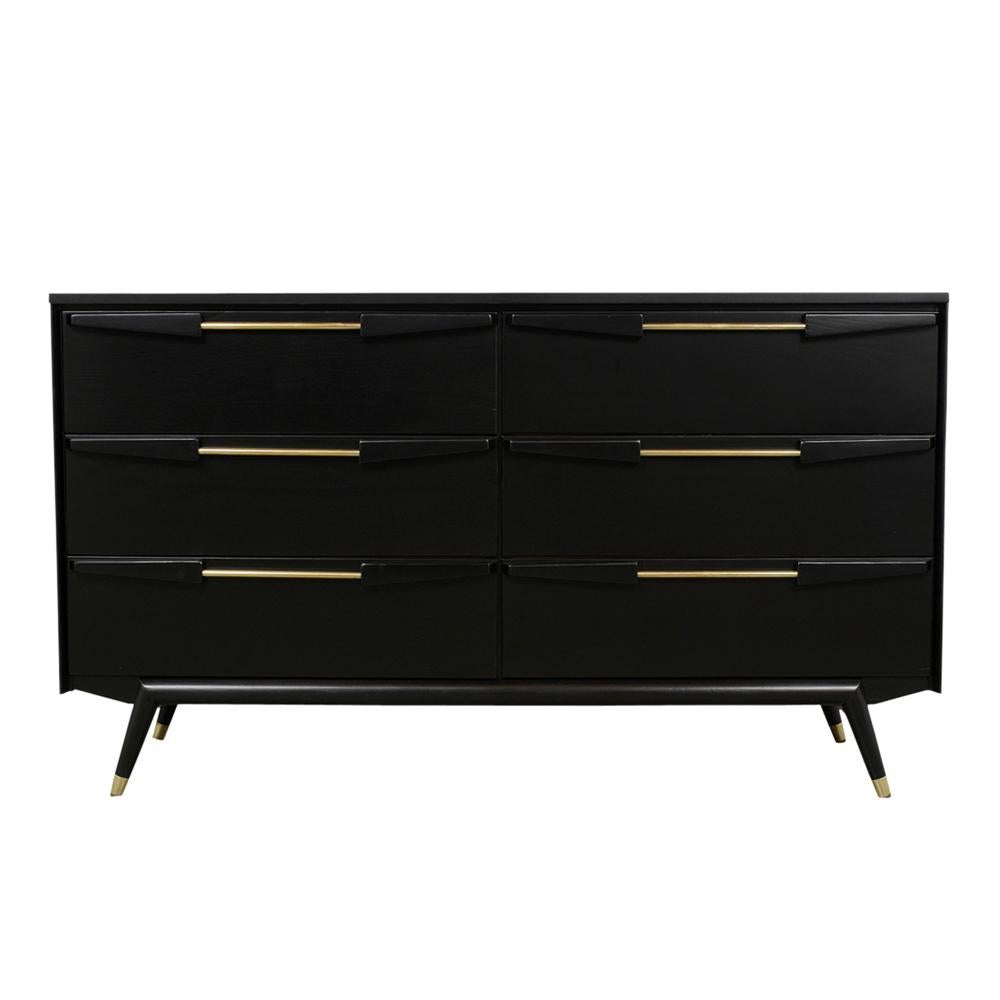 This is a 1960s modern style chest of drawers is stained a rich black color with a satin lacquered finish. It features six large front drawers, with large polished brass and wood handles. The chest rest on a stretch design tapered legs with brass