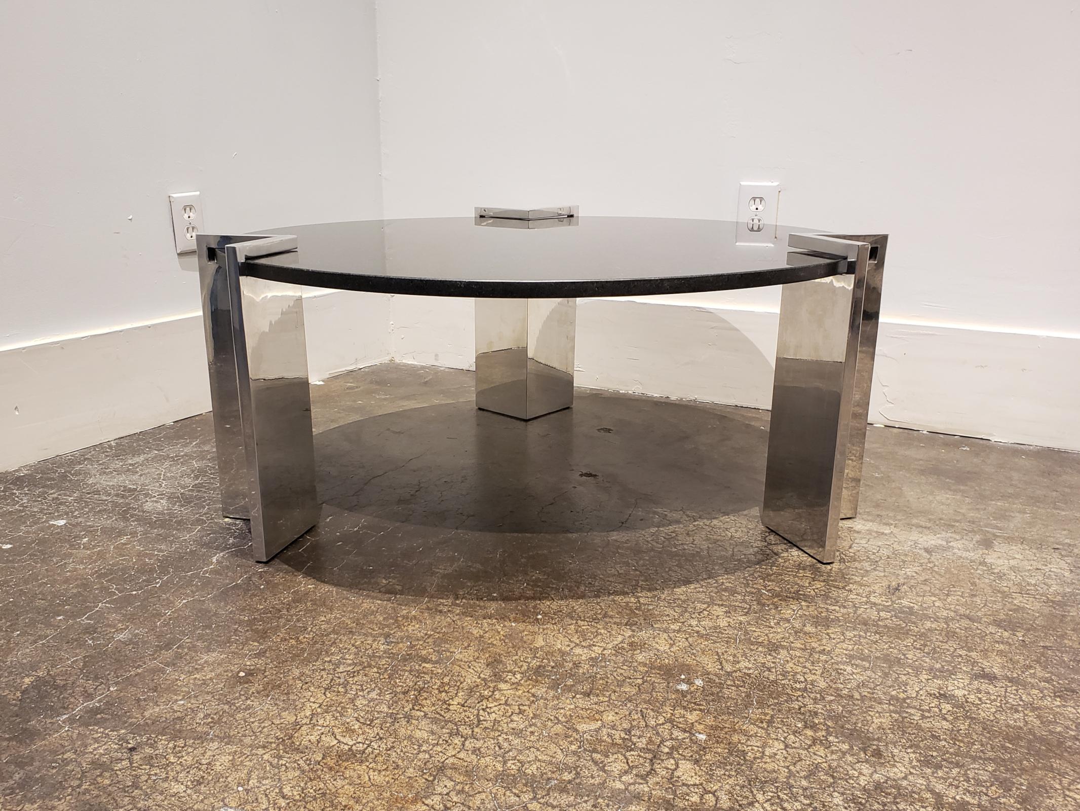 Beautiful modern coffee table with black granite top with white and gold specks. Has three thick, V-shaped, slip-on aluminum legs which come off for easy transport. Top is in great condition with no damage. Legs are in good condition with minor