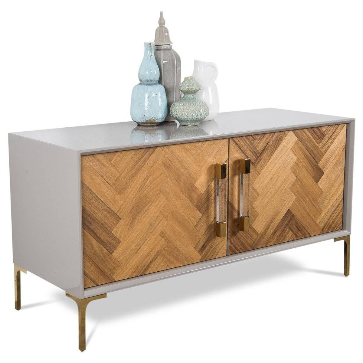 The Amalfi two-door credenza is perfect for any spaces, with oiled South American walnut finished doors. Surrounded by a greystone finish, the wood pieces placed on the doors create a large herringbone effect. The doors are finished off with our