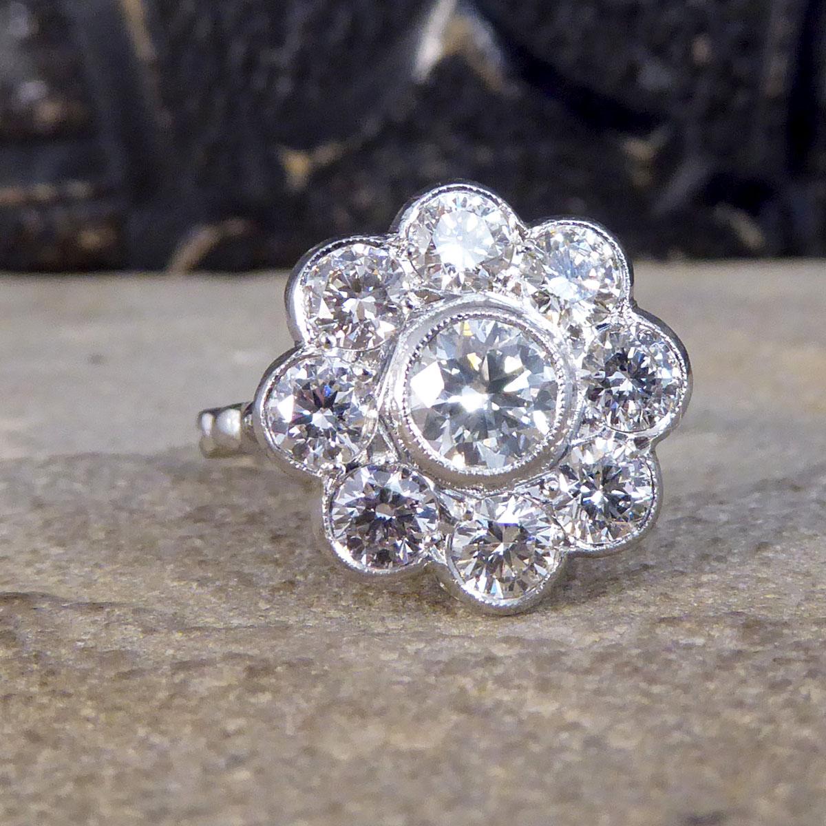 Such a stunning Daisy cluster ring set with Round Brilliant cut Diamonds giving it a total carat weight of 2.02ct with the centre being the largest with 8 surrounding stones. All set in Platinum with a milegrain edge, leading to a plain band and is