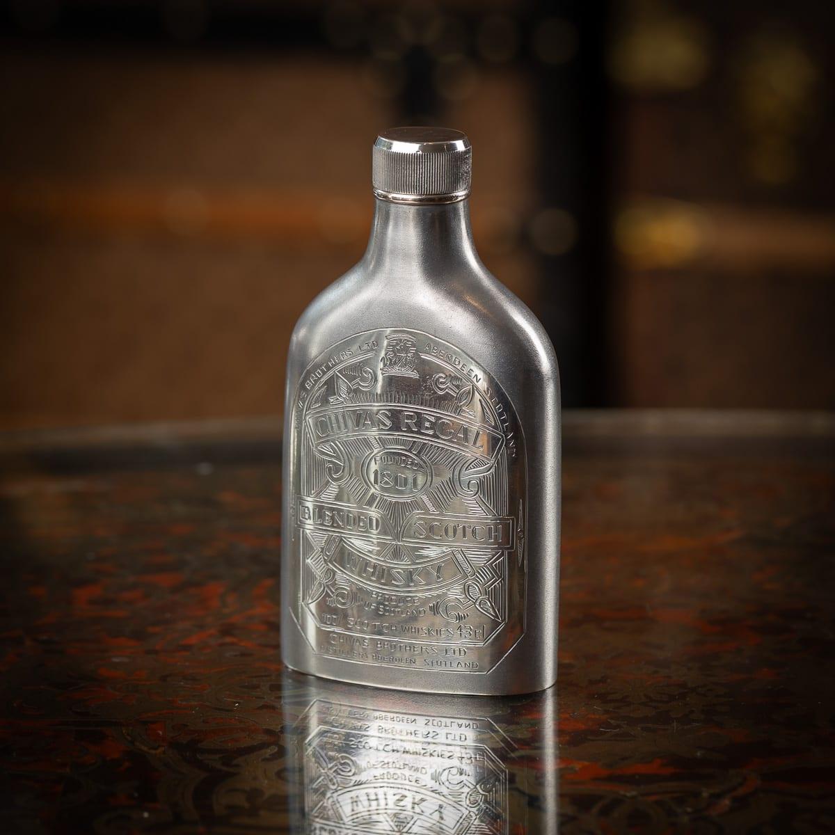 Modern 20th Century novelty solid silver Chivas Regal whisky bottle. A large and heavy-gauge piece of rounded form with a frosted finish, engraved with labels replicating the iconic Chivas branding. The base is stamped “SILVER.”

CONDITION
In Great
