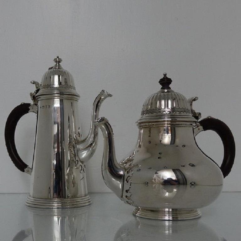 A very stylish Queen Anne copy tea and coffee set plain formed in design with elegant cut card work for highlights. The lids of the tea and coffee pots are hinged and are elegantly fluted in design. The handles have beautiful applied strap work for