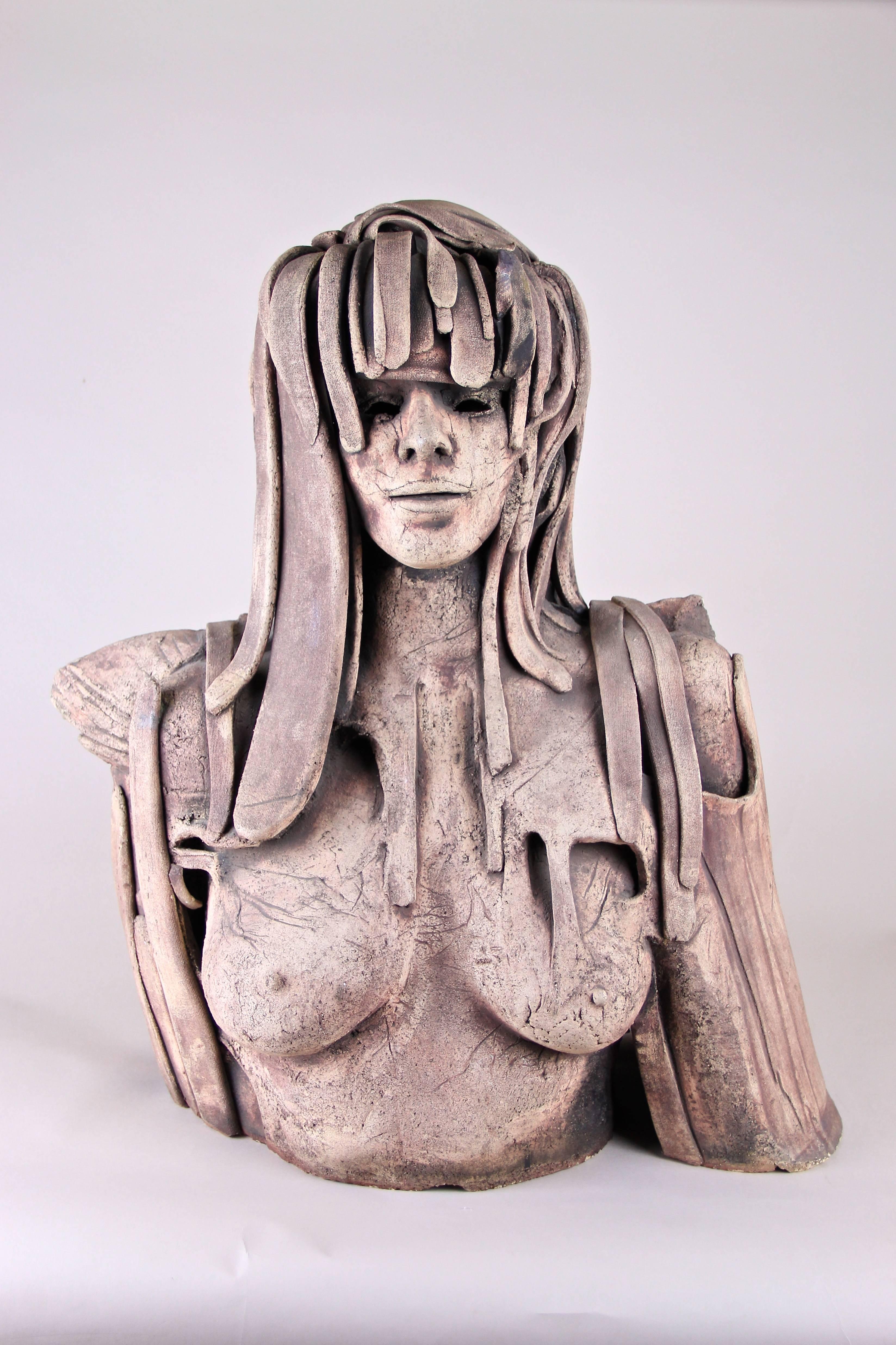 Out of the ordinary modern terracotta sculpture from the 1970s in Belgium. This large exceptional bust depicts a female postapocalyptic warrior processed in an very unique technique. Super realistic features, looking like a real face wrapped in