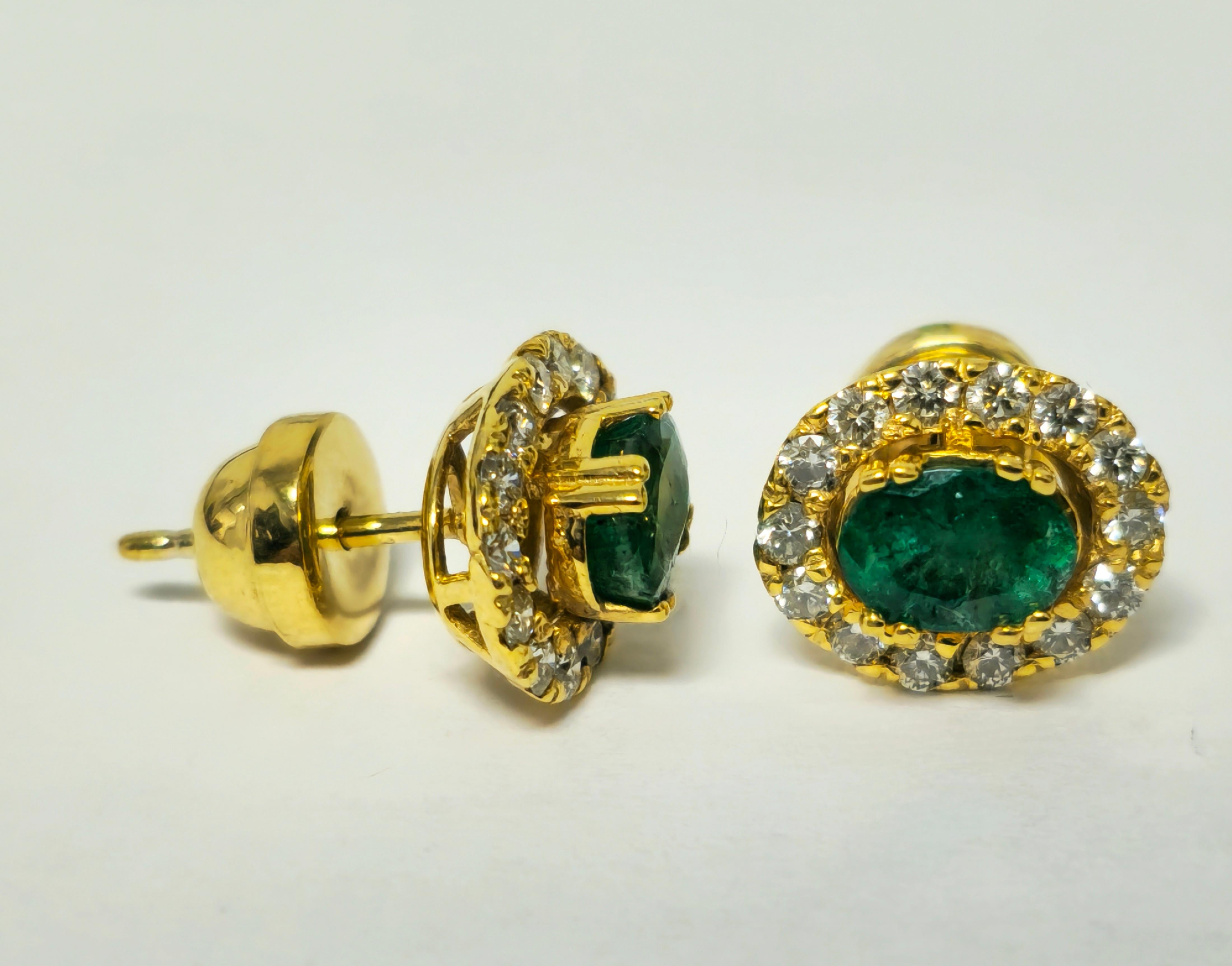 Fashioned from 14k yellow gold, these modern emerald diamond stud earrings boast a total of 2.50 carats of oval-cut emeralds, showcasing excellent color and saturation. Accompanied by 1.50 carats of round brilliant-cut diamonds with VS2 clarity and