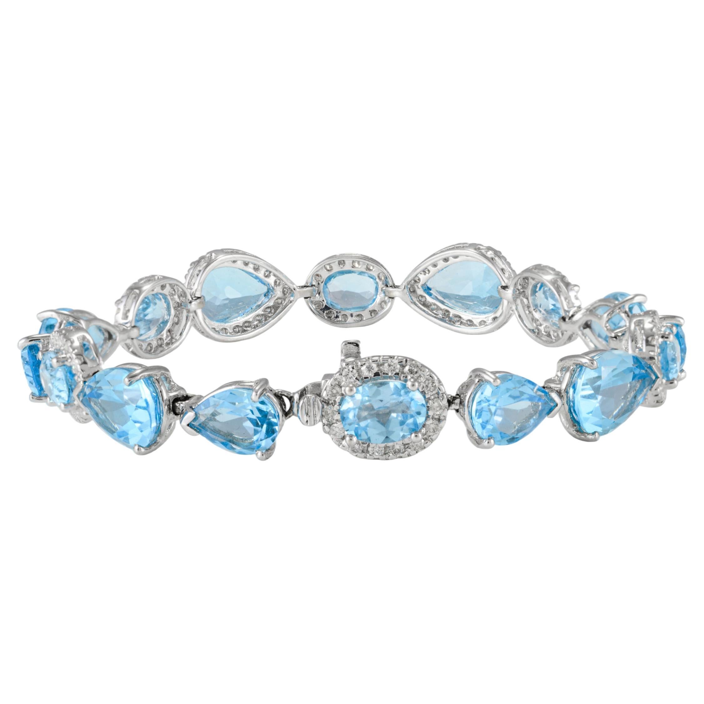 25.92ct Mixed Cut Blue Topaz and Halo Diamond Tennis Bracelet 18k White Gold For Sale