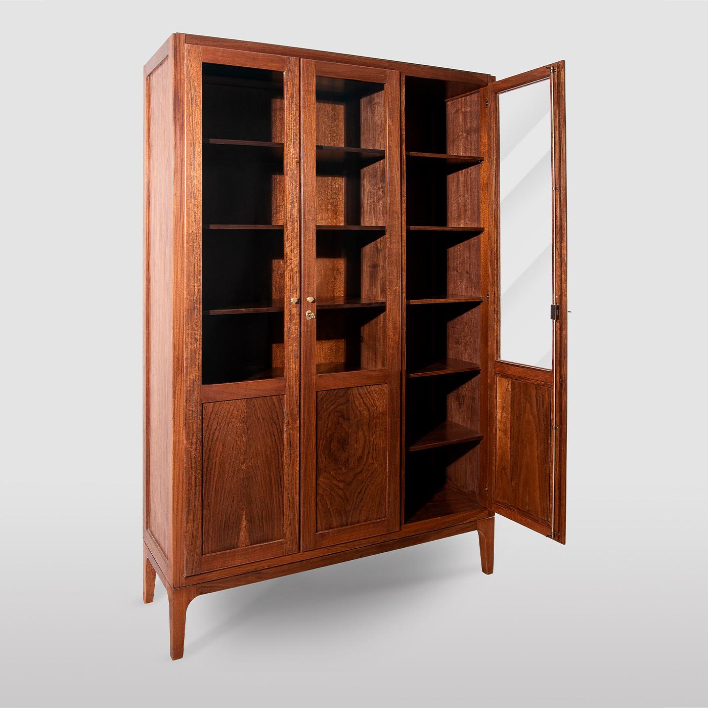 Handcrafted of solid Daniela walnut, this remarkable bookcase is the epitome of artisan cabinetry. The linear silhouette and minimal details allow the rich wood grain to take center stage. Equipped with ten shelves and an inner divider, the storage