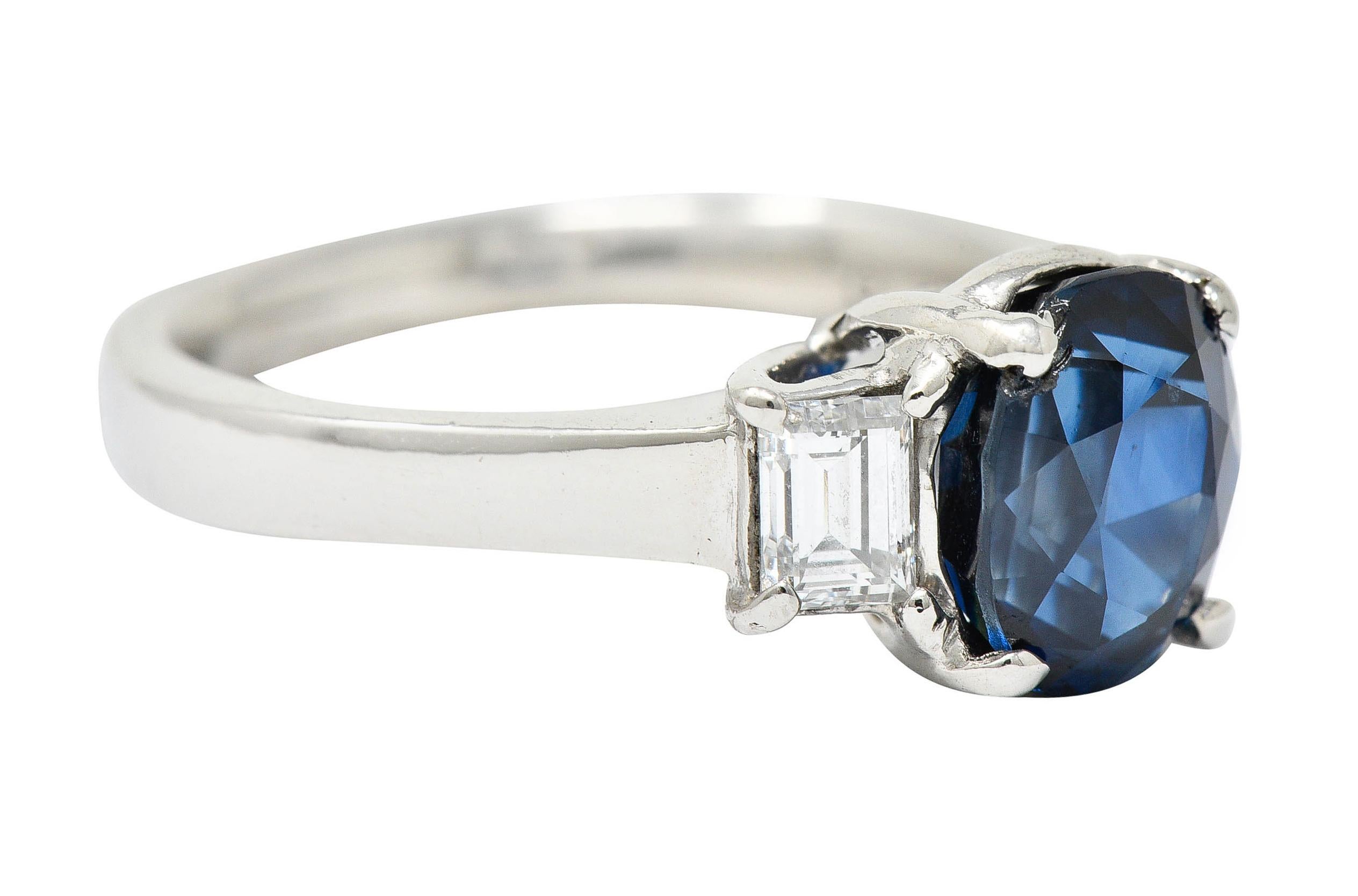 Designed as a basket set three stone ring

Centering an oval cut sapphire weighing approximately 3.00 carats - medium dark blue in color

Flanked by two rectangular step cut diamonds weighing in total approximately 0.36 carat - G/H color with VS