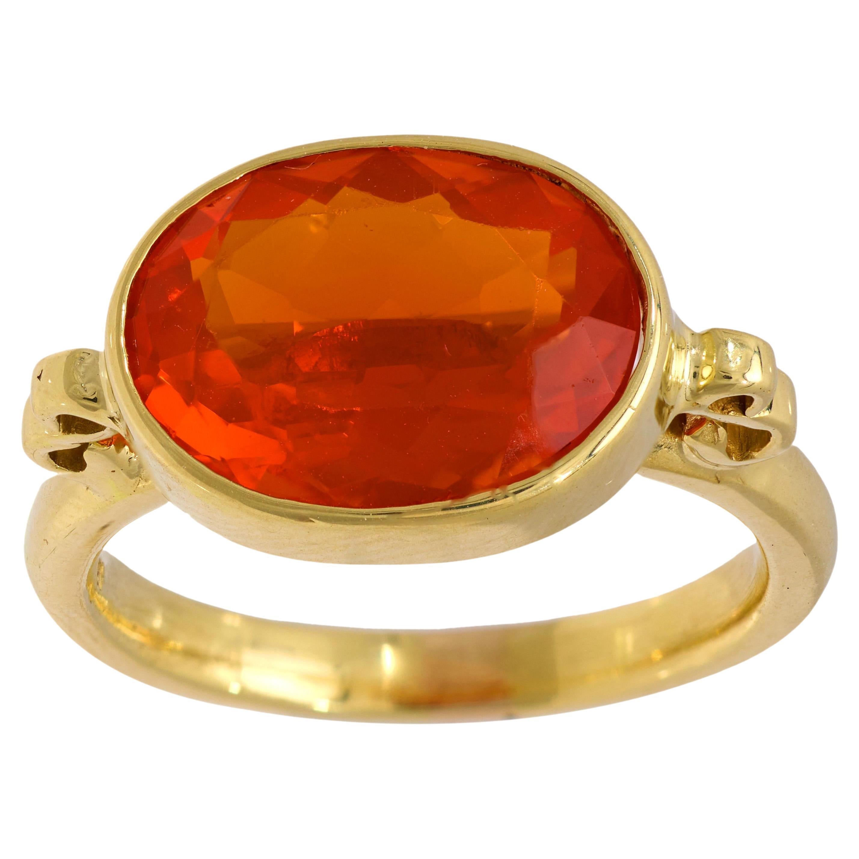 Modern 3.90 carat fire opal 18k yellow gold east-west bezel ring