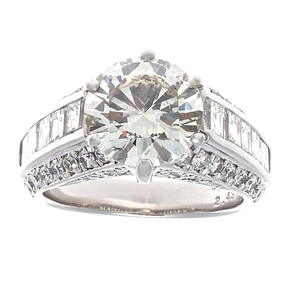 When bigger is better, this ring delivers. Serious finger coverage here, with one large round brilliant  4.06 carat M-N color, SI1 clarity diamond,  and a wide band full of sparkle, including 66 accenting diamonds weighing 2.43 carats H-I color