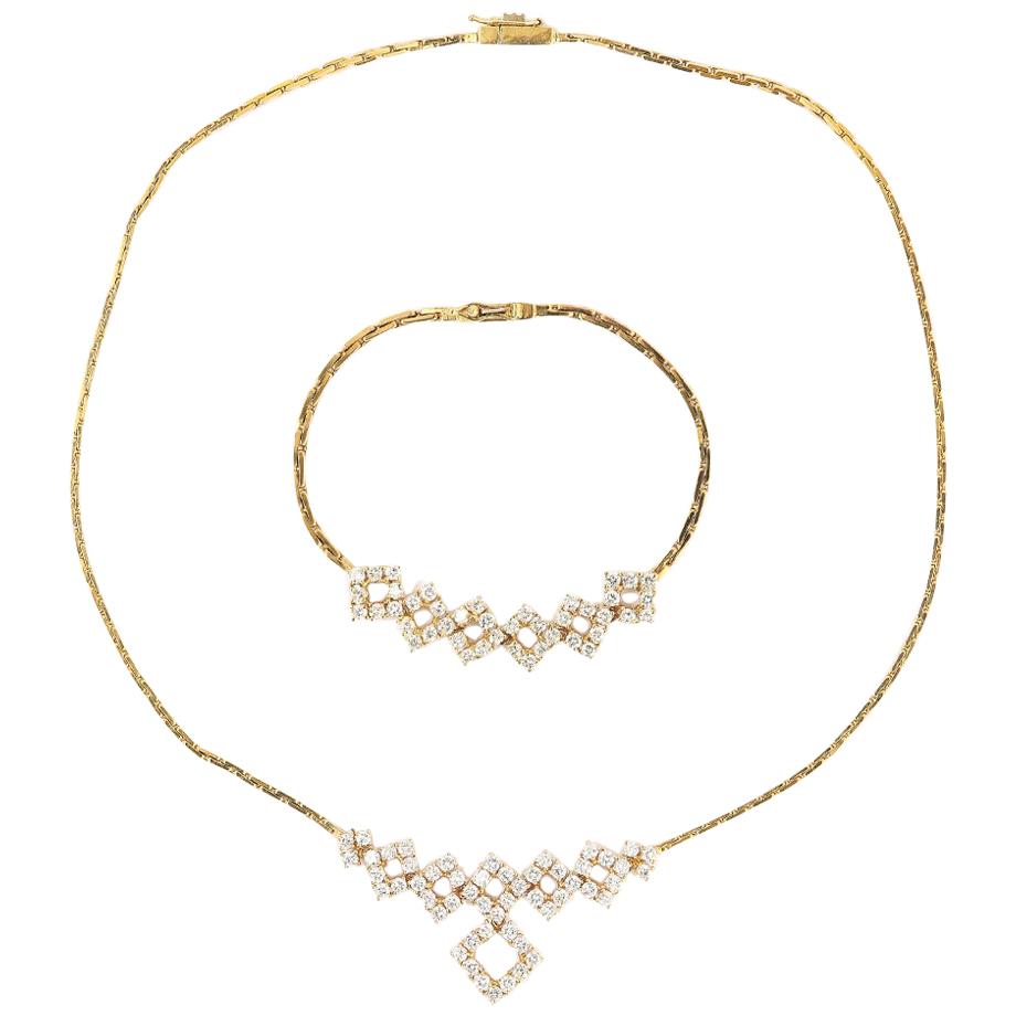 An attractive modern 18k yellow gold diamond set necklet with a matching bracelet. Total diamond weight for both the necklace and bracelet 4.80ct (approx).

The necklace design consists of an 18k flat link chain 42cm/16.5” long set with 53 0.05ct