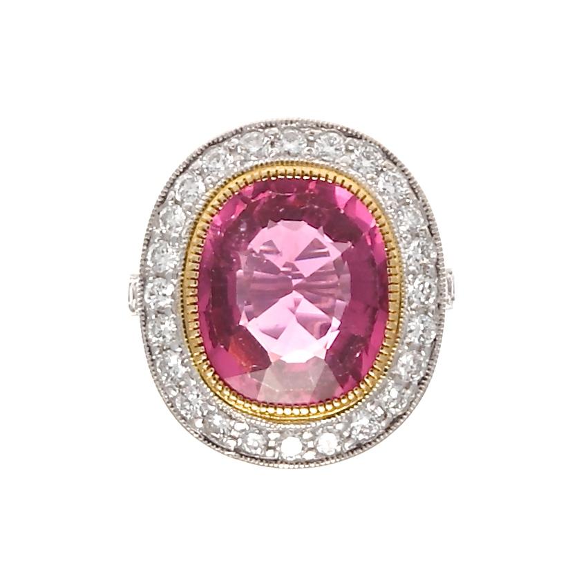 Exuberance is described as the quality of being full of energy, excitement, and cheerfulness. This is perfectly captured through this colorful artistic creation. Featuring a 6.29 carat vivid pinkish-red rubelite tourmaline that is tastefully