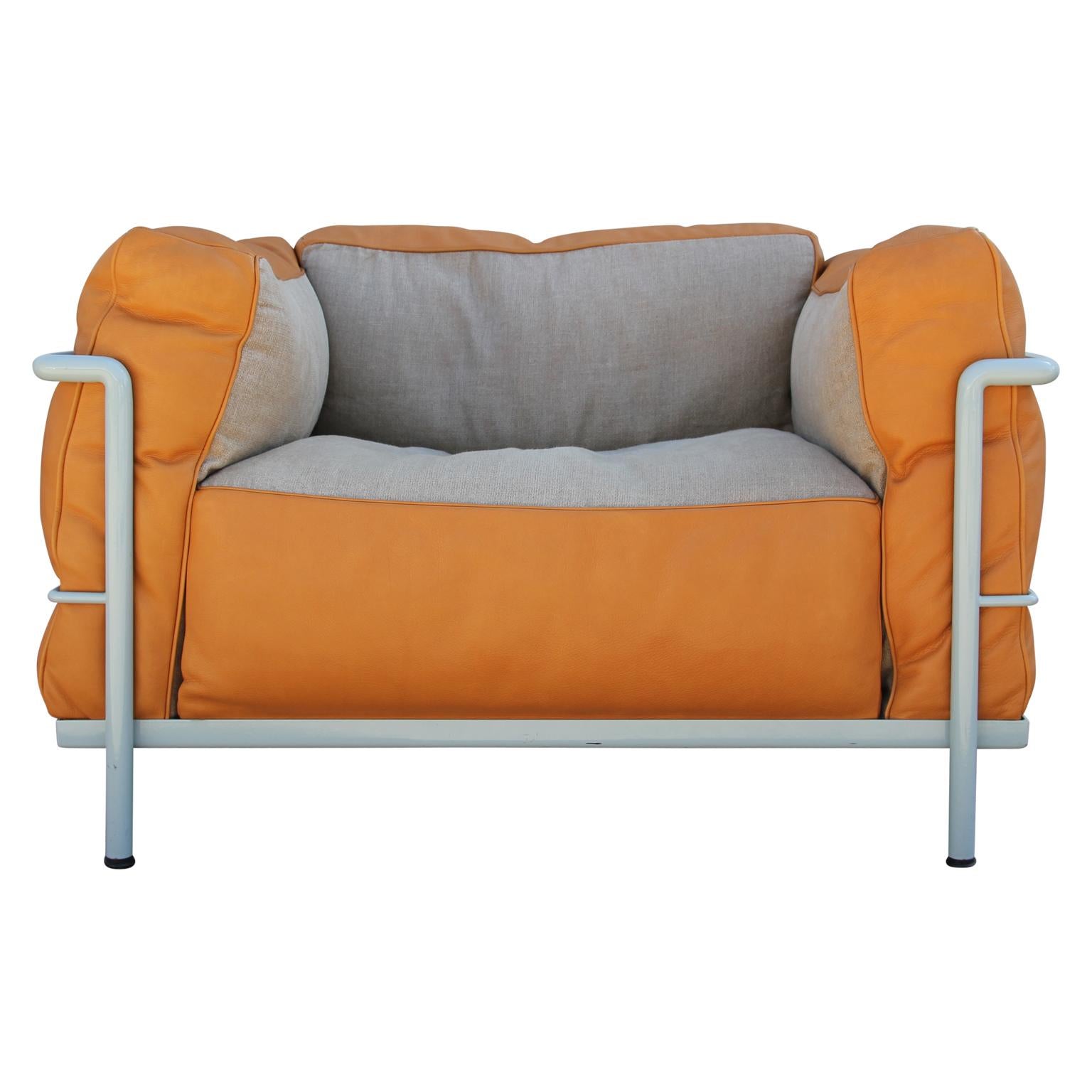 Unique limited edition LC3 Le Corbusier armchairs with orange leather and tan fabric cushions and white framing. The Le Corbusier group referred to their LC3 collections as 
