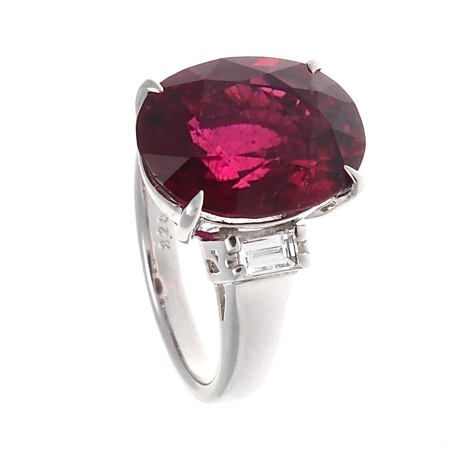 Featuring a vivid 8.20 carat red rubelite accented  by colorless baguette cut diamond. A gemstone is considered a rubelite when it is predominately red otherwise it is considered a tourmaline. Red rubelites are more distinctive and rare than