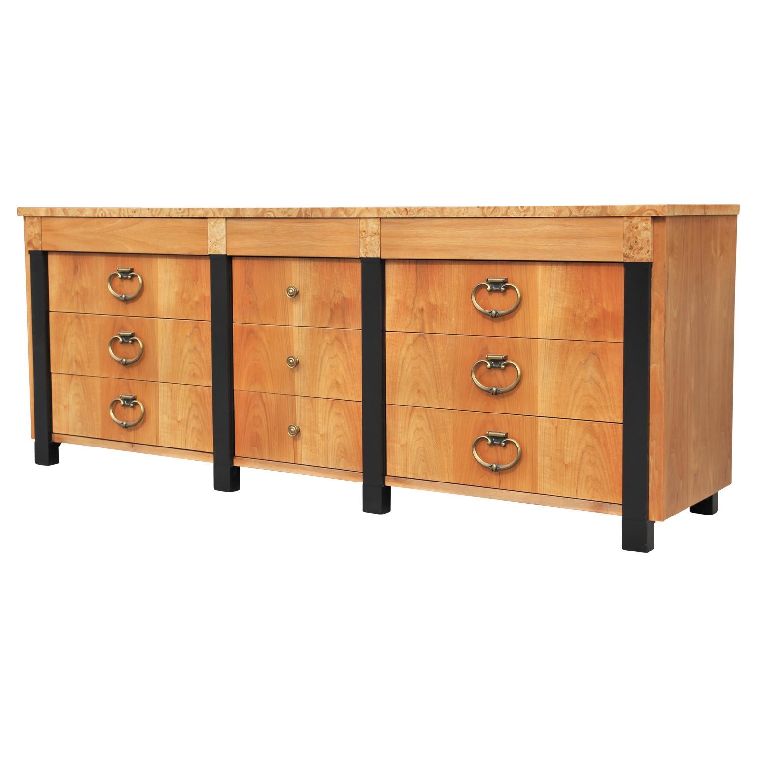 Modern 9 drawer dresser with burl trim and black columns Hollywood Regency. Classical design but with a modern finish.