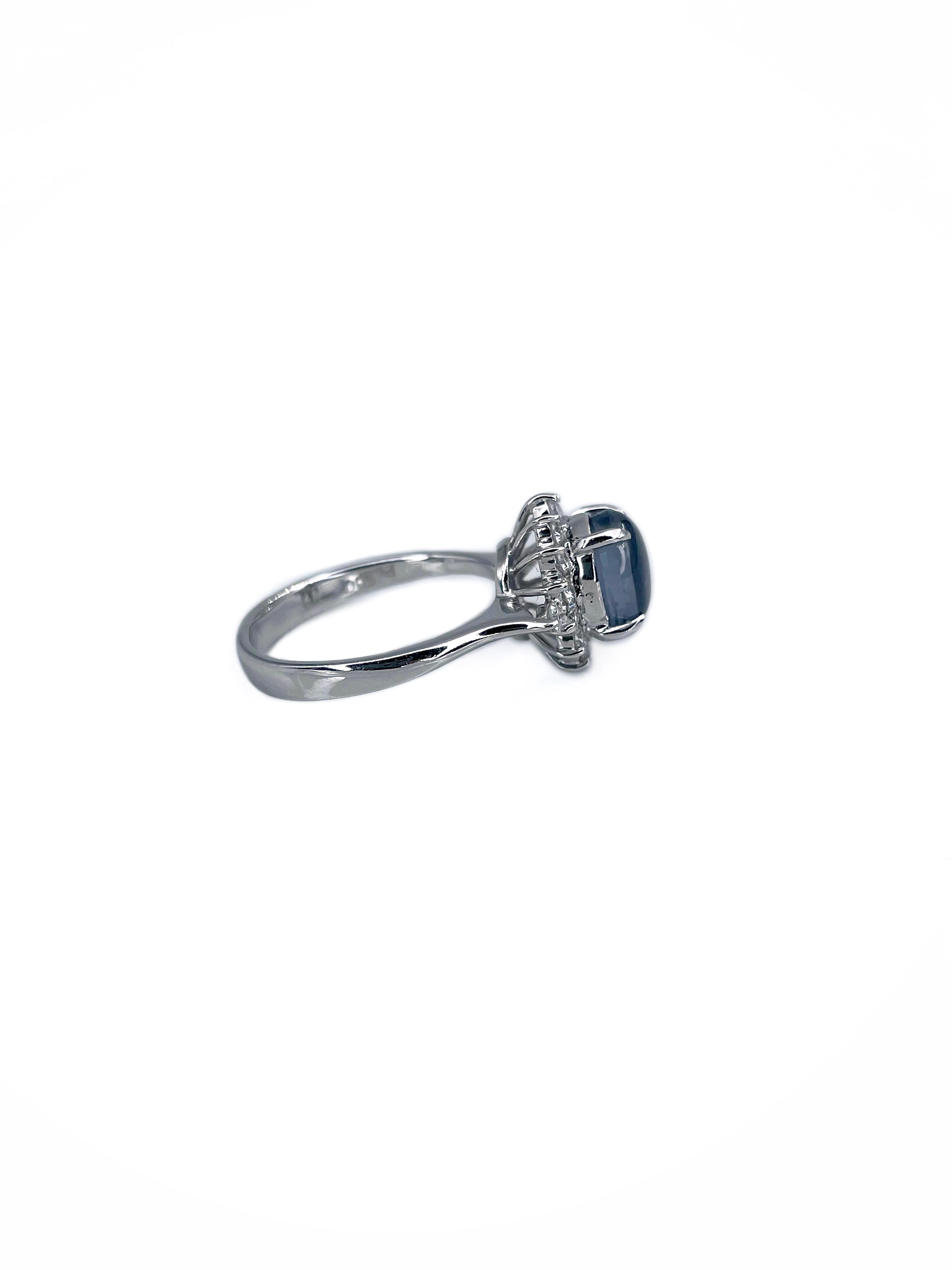 This is a modern cluster ring crafted in 900 hallmark platinum. Circa 1990. 

The piece features:  
- 1 sapphire, round shape, cabochon cut, 2.30ct, V 5/2, SI
- 16 diamonds, round brilliant cut, TW 0.35ct, RW-W, SI

Weight: 5.80g
Size: 16.5 (US