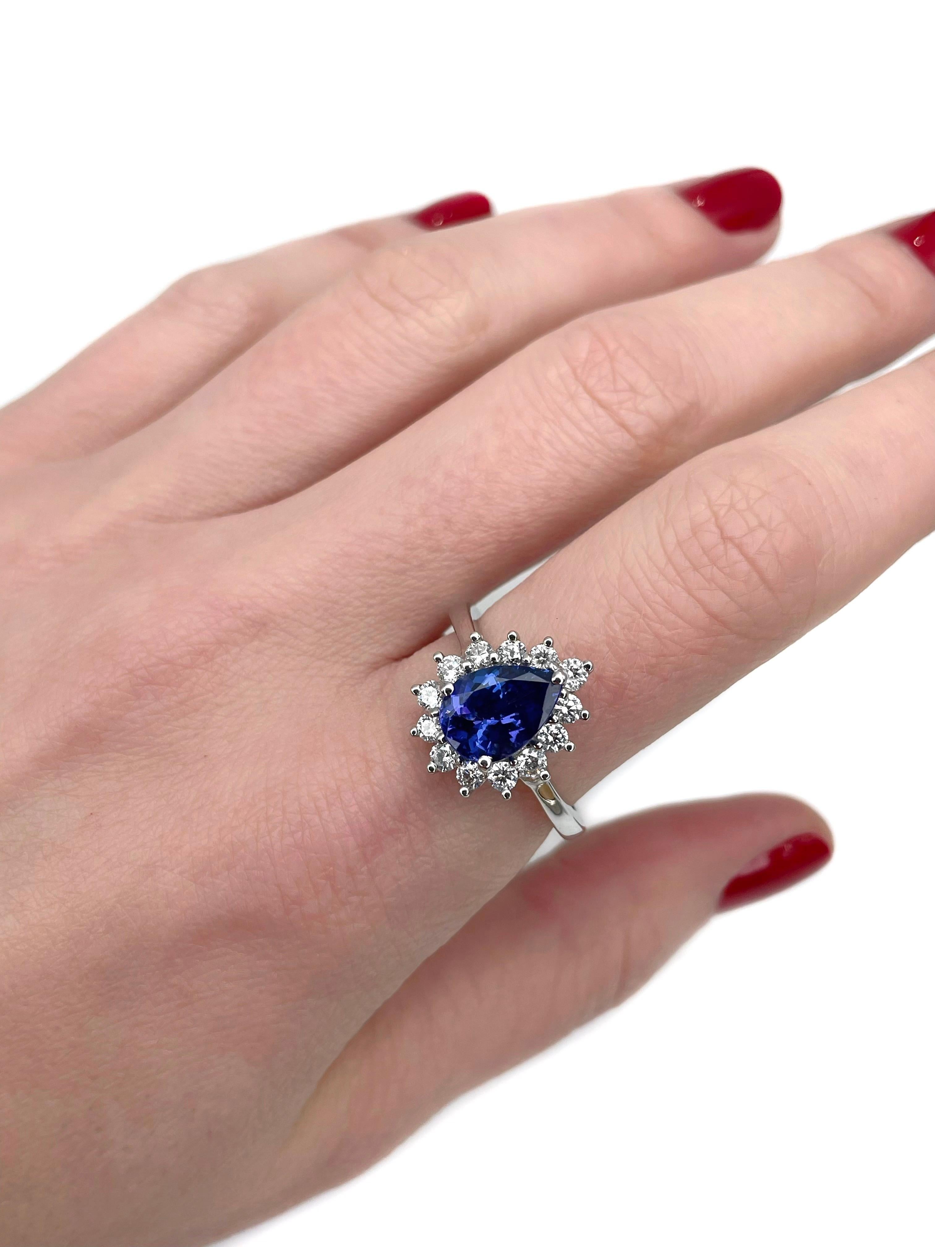 This is a modern cluster ring crafted in 950 platinum. Circa 2010. 

The piece features:
- 1 tanzanite (pear cut, 2.00ct, V 6/4, VS)
- 13 diamonds (round brilliant cut, TW 0.60ct, RW-W, VS-SI) 

Signed with “Rhapsody”, “PT 950”

Weight: 7.69g
Size: