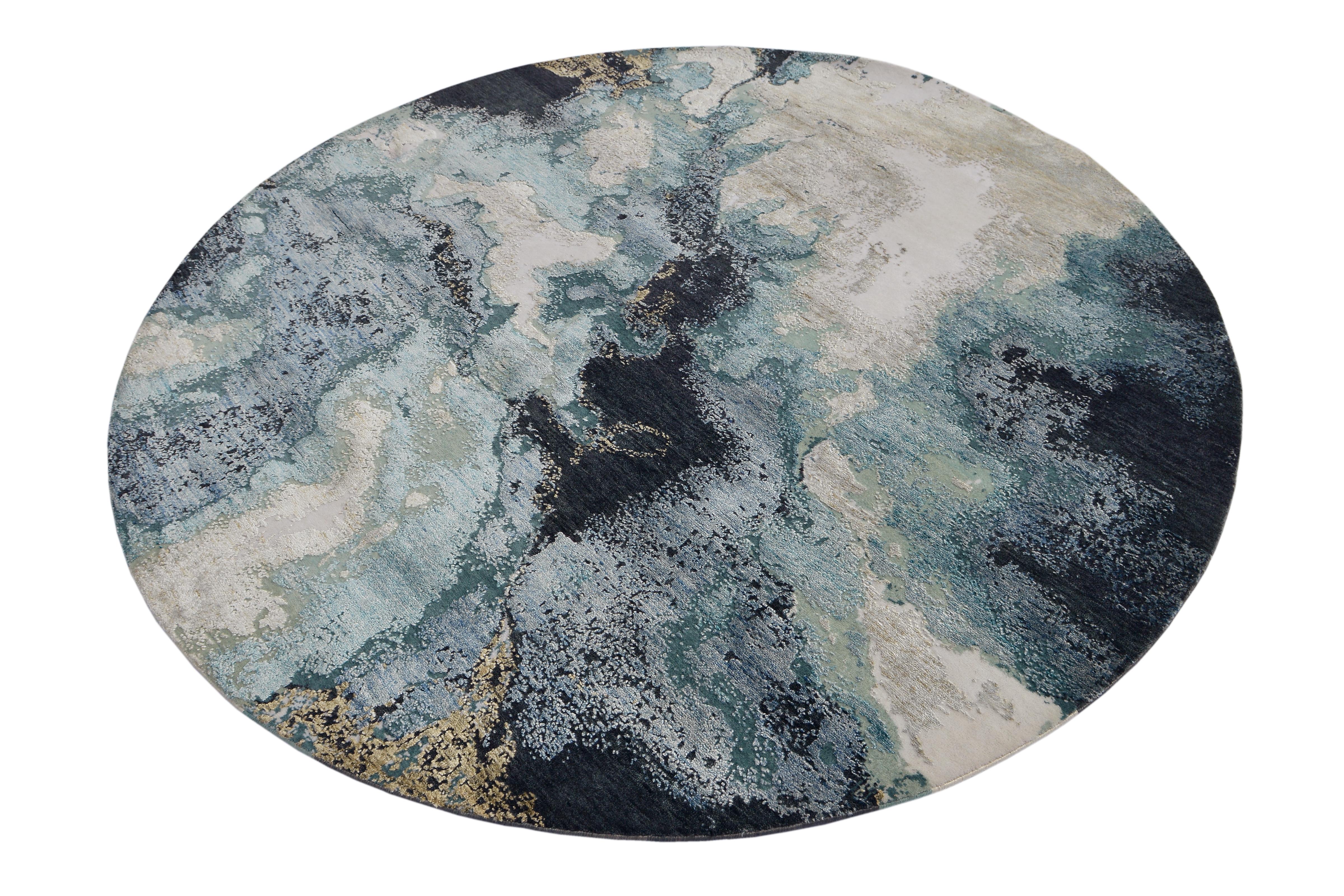 A new addition to the handmade rugs in the abstract rug line by Rug & Kilim, this 6'8” x 6'8” round modern rug is hand knotted in a unique, proprietary blend of quality wool and silk, the natural luster of the latter bringing out modern hues of