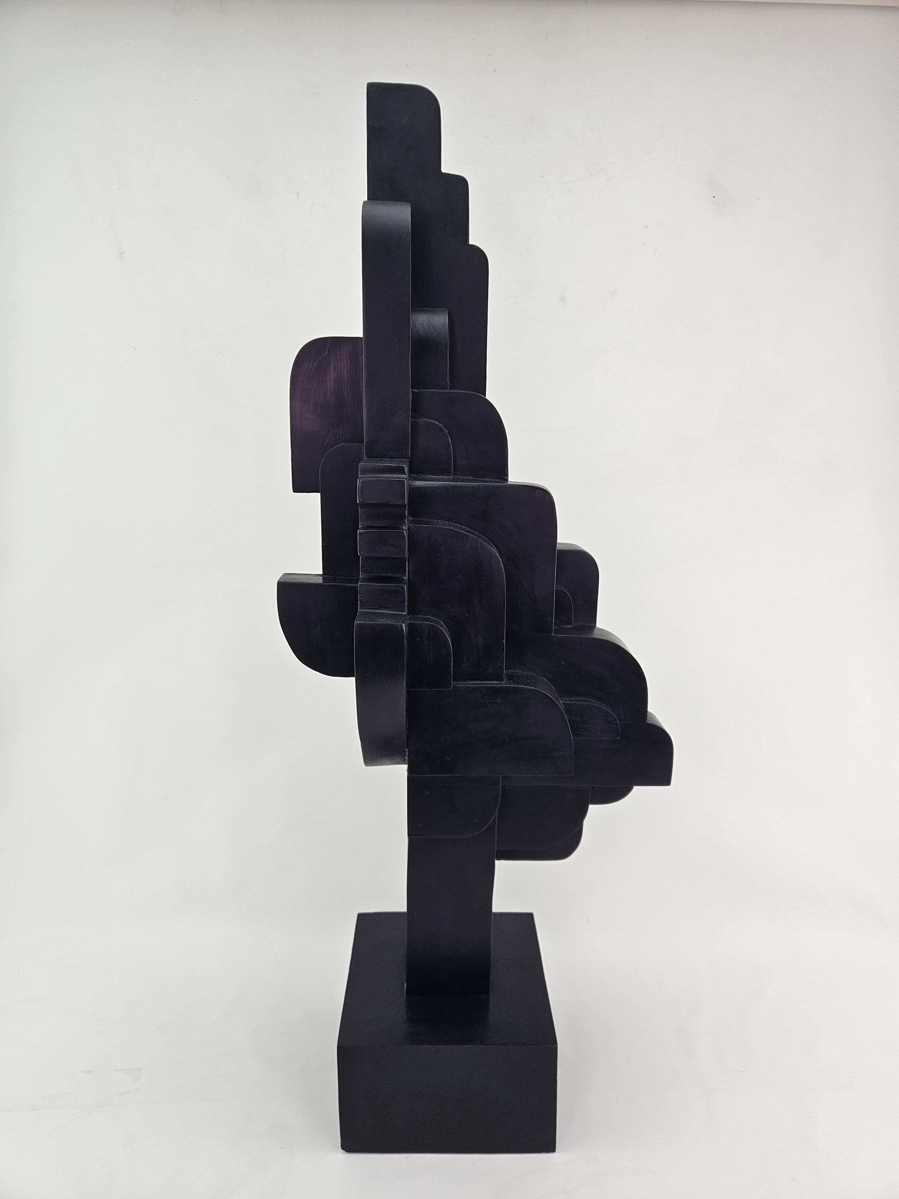 This contemporary abstract wooden sculpture is by Czeslaw Budny in constructivist style circa 2024. This unique sculpture is made of recycled wood. Budny utilizes the simplicity of shapes such as the cube, circle and triangle to create modern