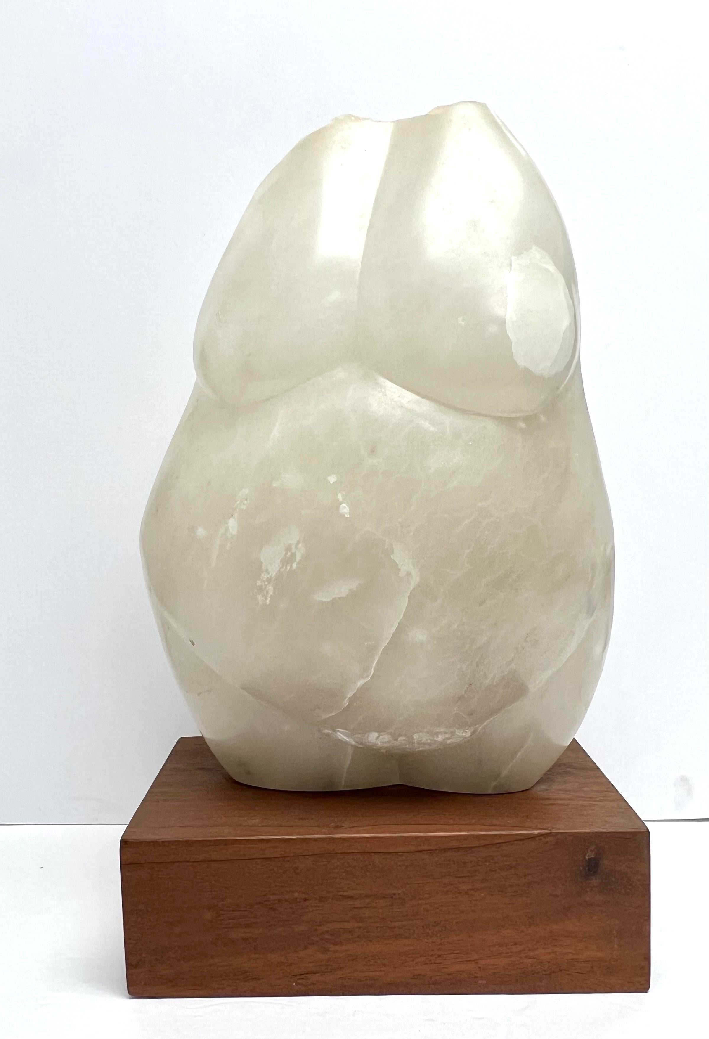A modern marble sculpture of a female torso. Mounted on a walnut base. Great looking from every angle.
