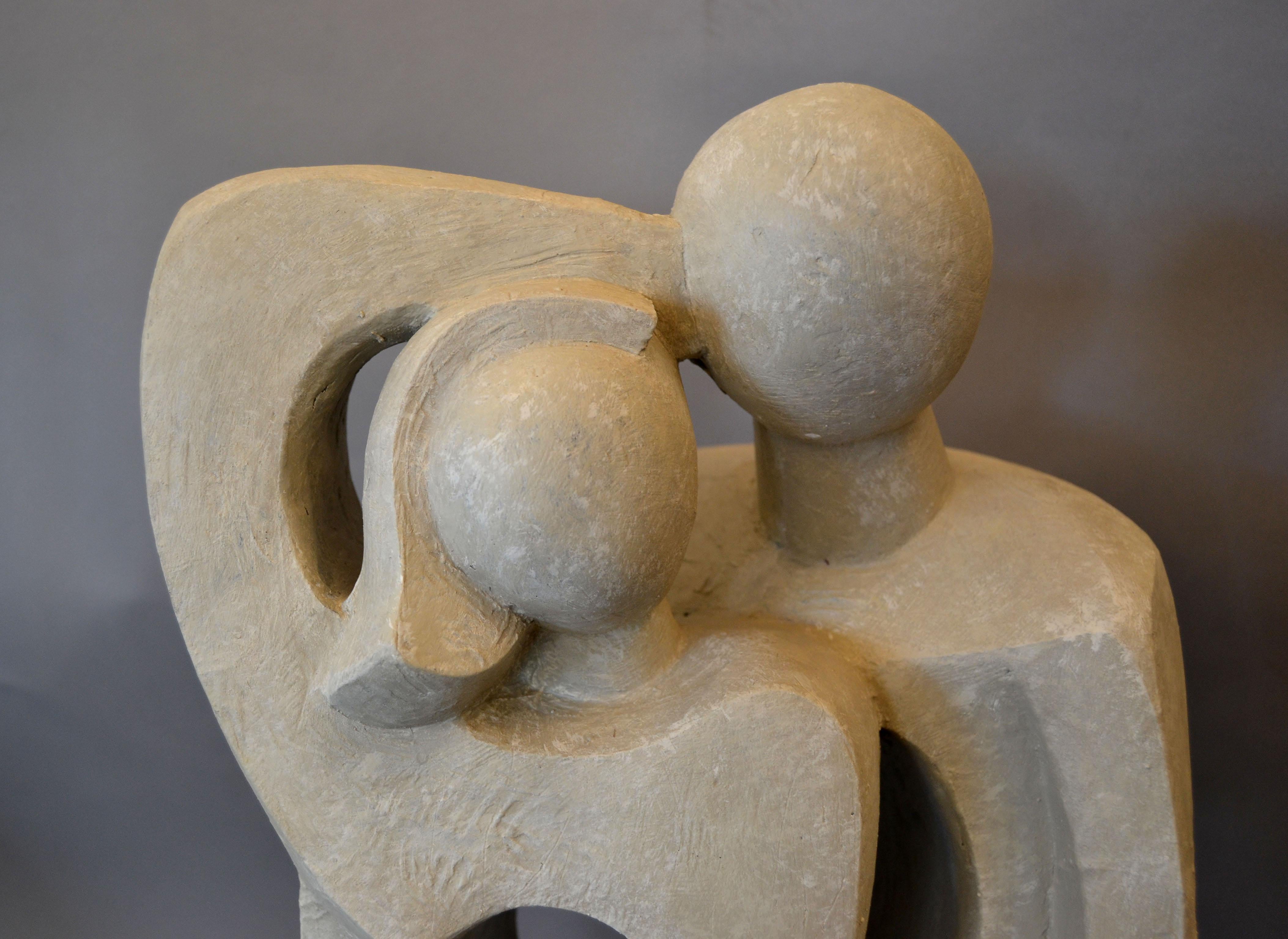 Modern abstract Geometric stylized embracing loving couple sculpture, figurine, statue in gray plaster.
Very minimalistic with clear lines and still graceful.