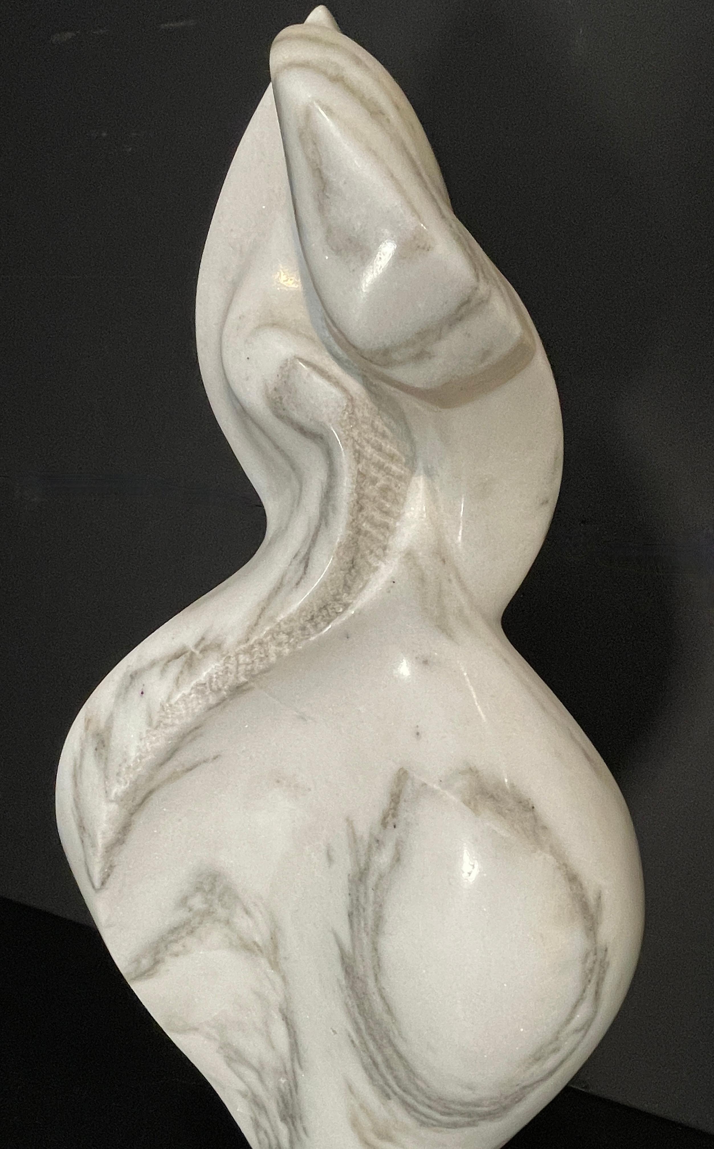 Signed carved white Carrara marble sculpture, abstract figure mounted and swivels on green marble base. 

Luis R Cuevas (1932–2019). Contemporary. Born in Utuado, Puerto Rico. Was active and lived in California.
Born in Utuado, Puerto Rico, Luis