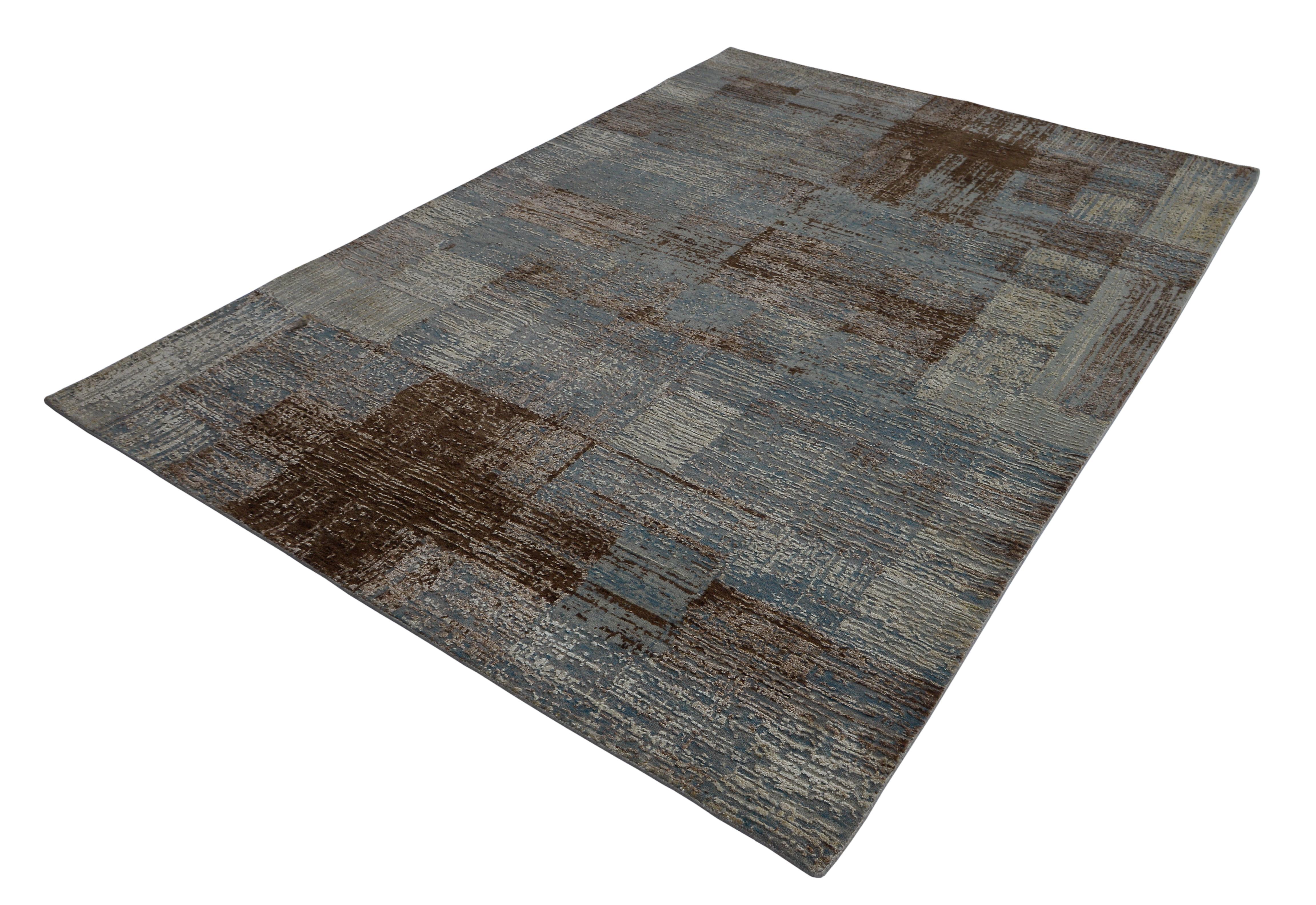 A new addition to the handmade rugs in the abstract rug line by Rug & Kilim, this 5'9” x 8'2” modern rug is hand knotted in a unique, proprietary blend of quality wool and silk, the natural luster of the latter bringing out transitional hues of