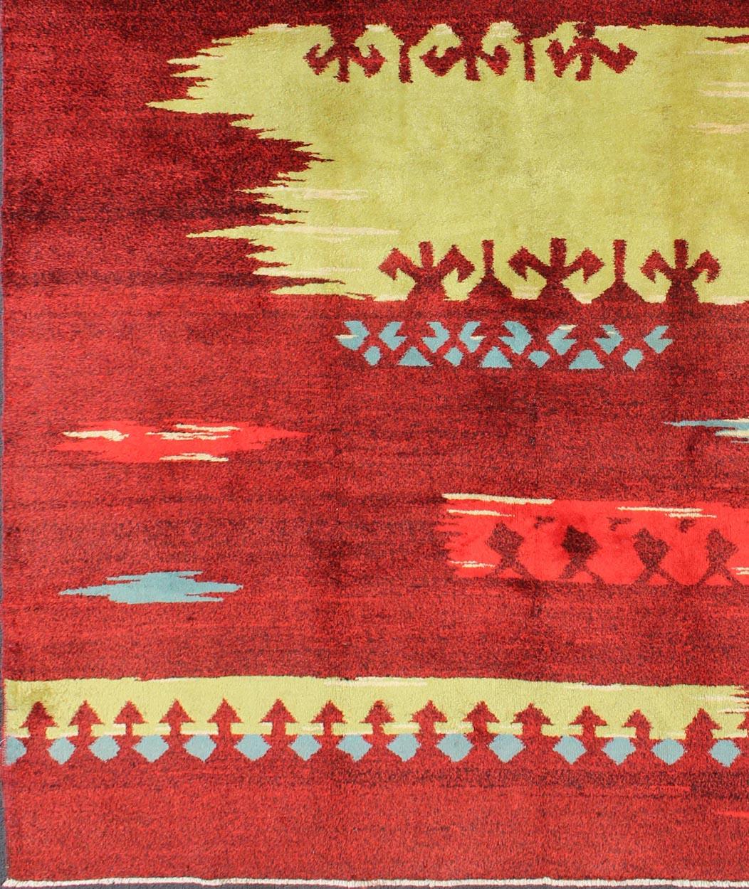 Modern Abstract Rug in  Maroon, Barn Red, Carmine, Crimson and Lime Green.
Rendered in a red background with an assortment of yellow-green, blue and ivory colors, this unique Turkish rug displays an abstract design.
Measures: 7' x 10'5
List Price 
