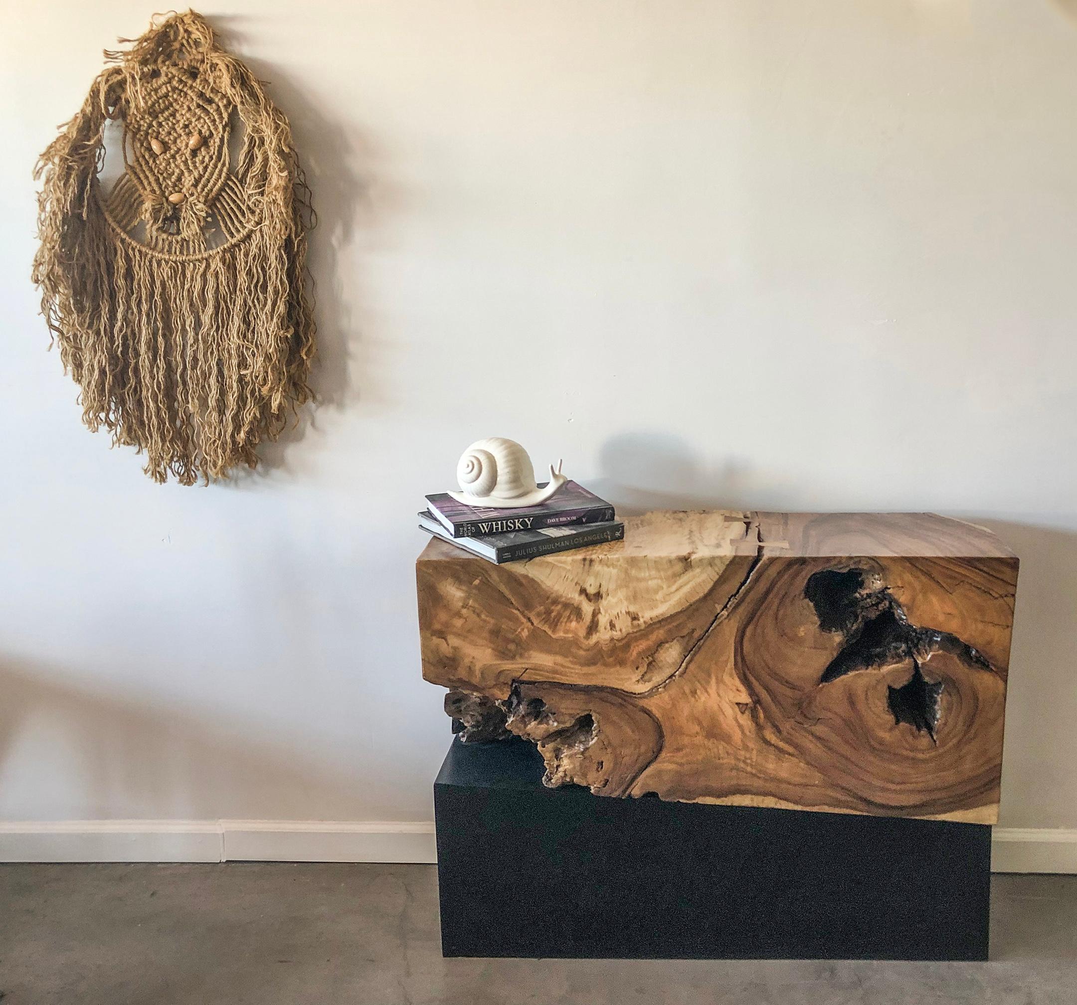 This console table is absolutely stunning! It features a modern, metal, asymmetrical base, with a solid, freeform acacia wood top. The wood on this piece is so sculptural and the butterfly joinery on top is gorgeous.