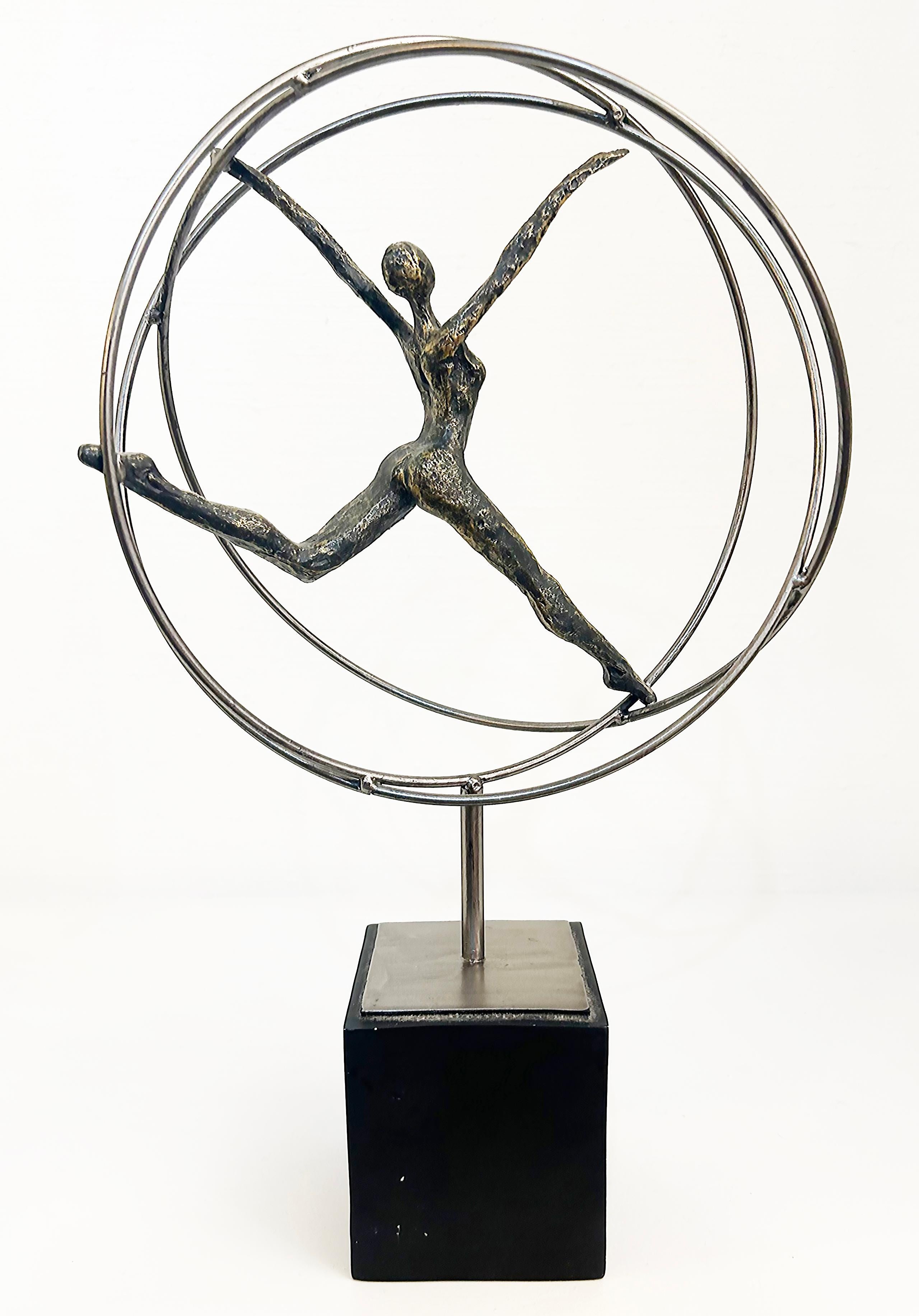 Modern Acrobats on Rings Figurative Metal Sculpture Mounted on Square Base

Offered for sale is a modern metal sculpture of an acrobatic figure in brass dancing within multiple metal rings.  The sculpture is supported by a stem that rises from a